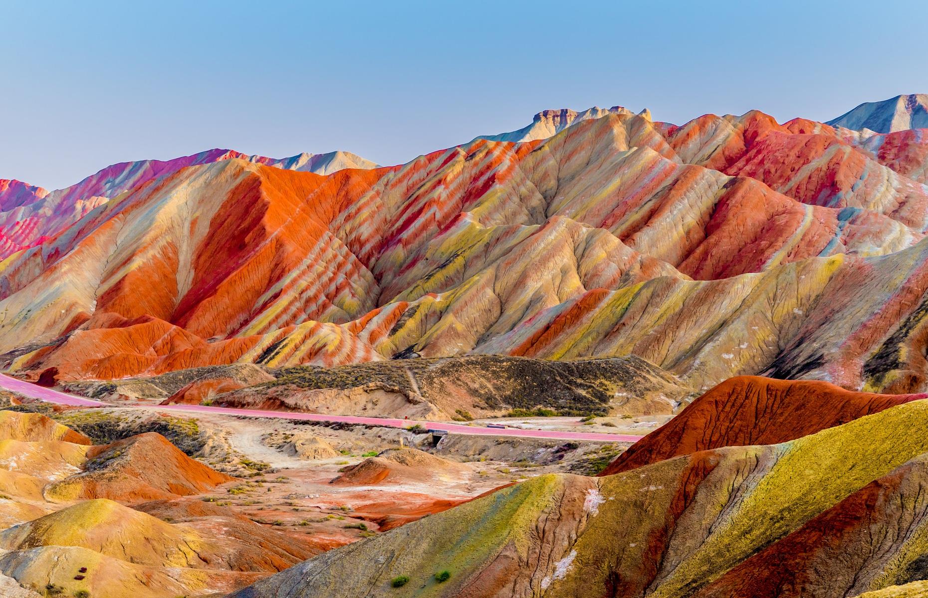 Slide 22 of 59: The rainbow-hued mountains in Zhangye National Geopark looks just like an artist's paint palette. Part of an UNESCO World Heritage Site, this stunning formation was created by natural erosion, when layers of sand, silt, iron and minerals blended together to create a kaleidoscope of colors. The incredible park appears to have been decorated by Mother Nature herself.