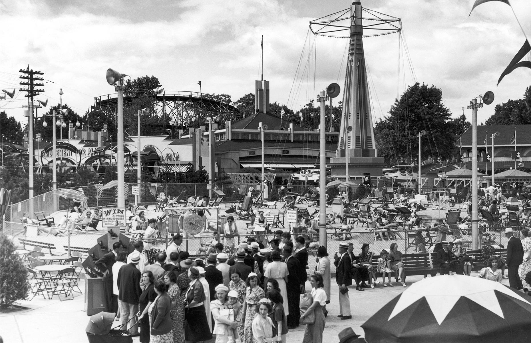 Slide 22 of 31: A stretch of sand and plenty of rides and roller coasters pulled visitors in to Palisades, a kitsch amusement park in New Jersey. It operated from the late 1890s right up until the 1970s. This nostalgic snap shows pleasure seekers milling about beneath the rides and on the little beach circa 1947. Check out more historic photos of theme parks in their heyday.