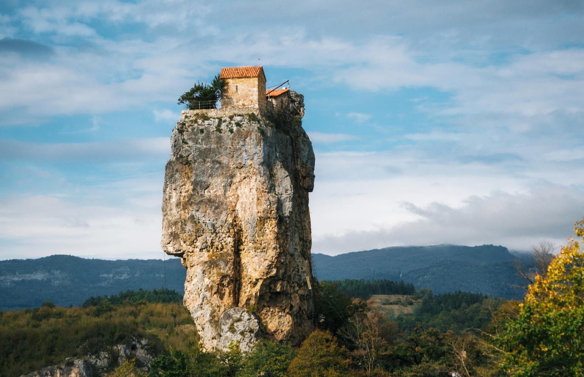 <p>Nestled in the western Georgian region of Imereti, the Katskhi Pillar takes extreme living to new heights. Towering 130 feet, the stone column is home to a church, built in the 6th- to 8th-centuries, a burial chamber and a cottage. An iconic religious landmark in the area, the precarious spot has also housed one devout monk for over 20 years.</p>