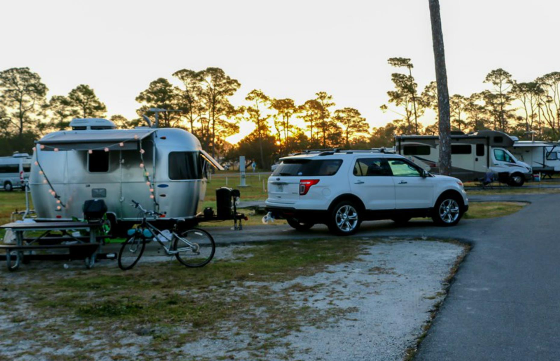 <p>This skinny spit of blazingly white sand, dissected by a road, straddles Mississippi and Florida. Each state has a <a href="https://www.nps.gov/guis/planyourvisit/campgrounds.htm">campground with RV sites</a> surrounded by sand, scrub oaks and the sparkling waters of the Gulf of Mexico. There are also day-use parking areas, from where it’s possible to pad down to the water’s edge for a picnic. Imposing former military facility Fort Pickens looms on the Florida side of the park, in Pensacola Bay. The campgrounds are currently closed due to COVID-19 – the <a href="https://www.nps.gov/guis/planyourvisit/campgrounds.htm">park website</a> has updates.</p>