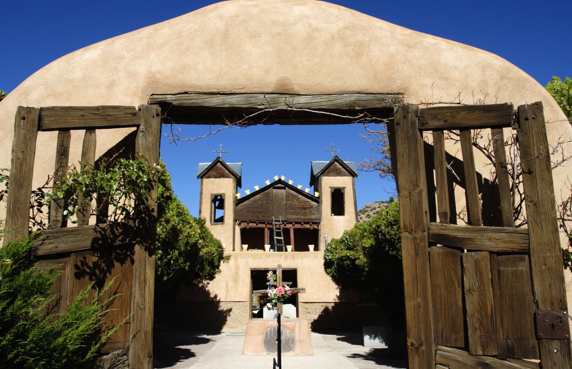 <p>A fascinating stop is the Picuris Pueblo, one of New Mexico’s smallest pueblos, whose riverside setting makes it particularly picturesque. Other highlights include the little villages of Chimayó (pictured), Talpa and Ranchos de Taos, all home to stunning historic churches. The final reward is Taos, with its famous pueblo and photogenic historic district. The pueblo is temporarily closed to visitors, but <a href="https://taospueblo.com/">check for changes on the website</a>. </p>