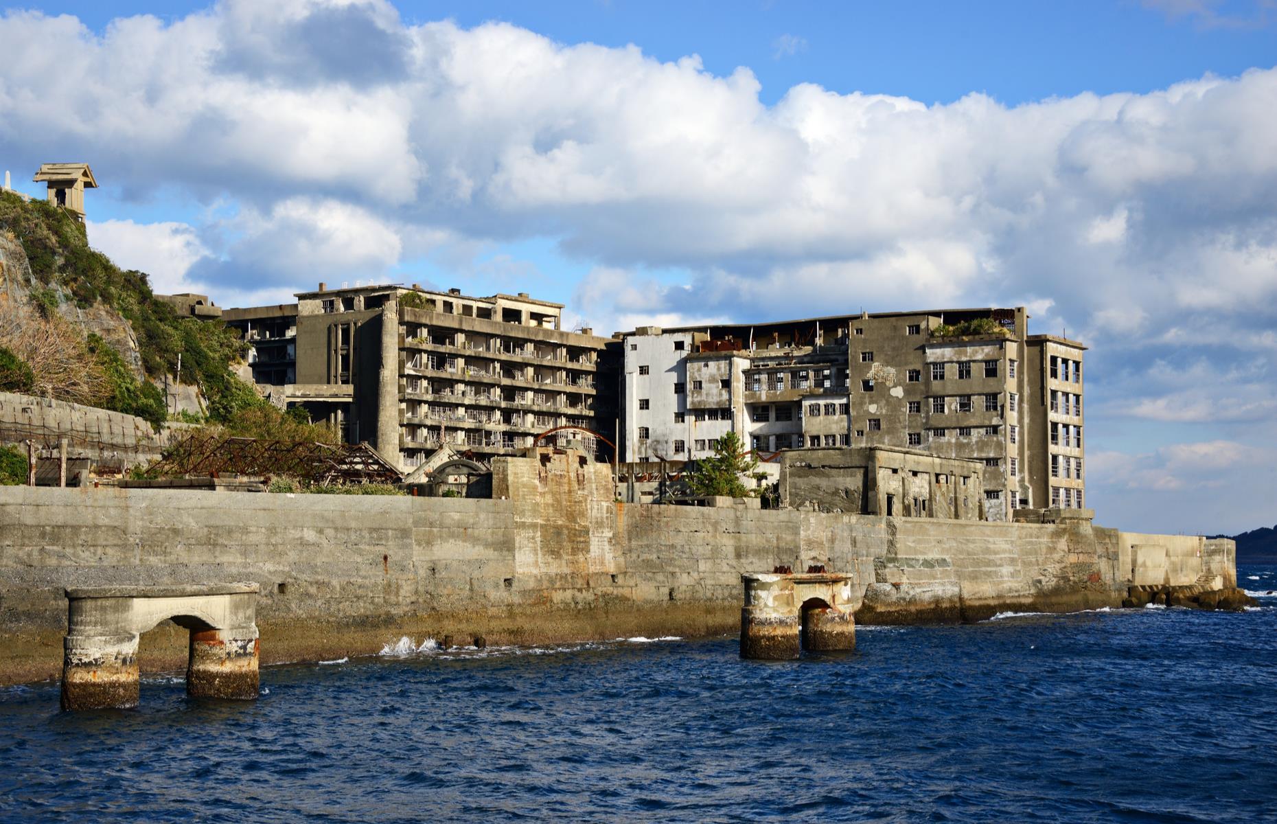 Slide 3 of 35: In its heyday, around the 1940s and 1950s, thousands of people lived on the isle and industry boomed. It’s reported, though, that hundreds of the mine workers were laborers from Korea who were forced to work here. The island's natural resources eventually dried up, the mines closed in the 1970s and the island was abandoned. Now organized tours take curious visitors to the island with its crumbling apartment blocks, overgrown courtyards and deserted streets.