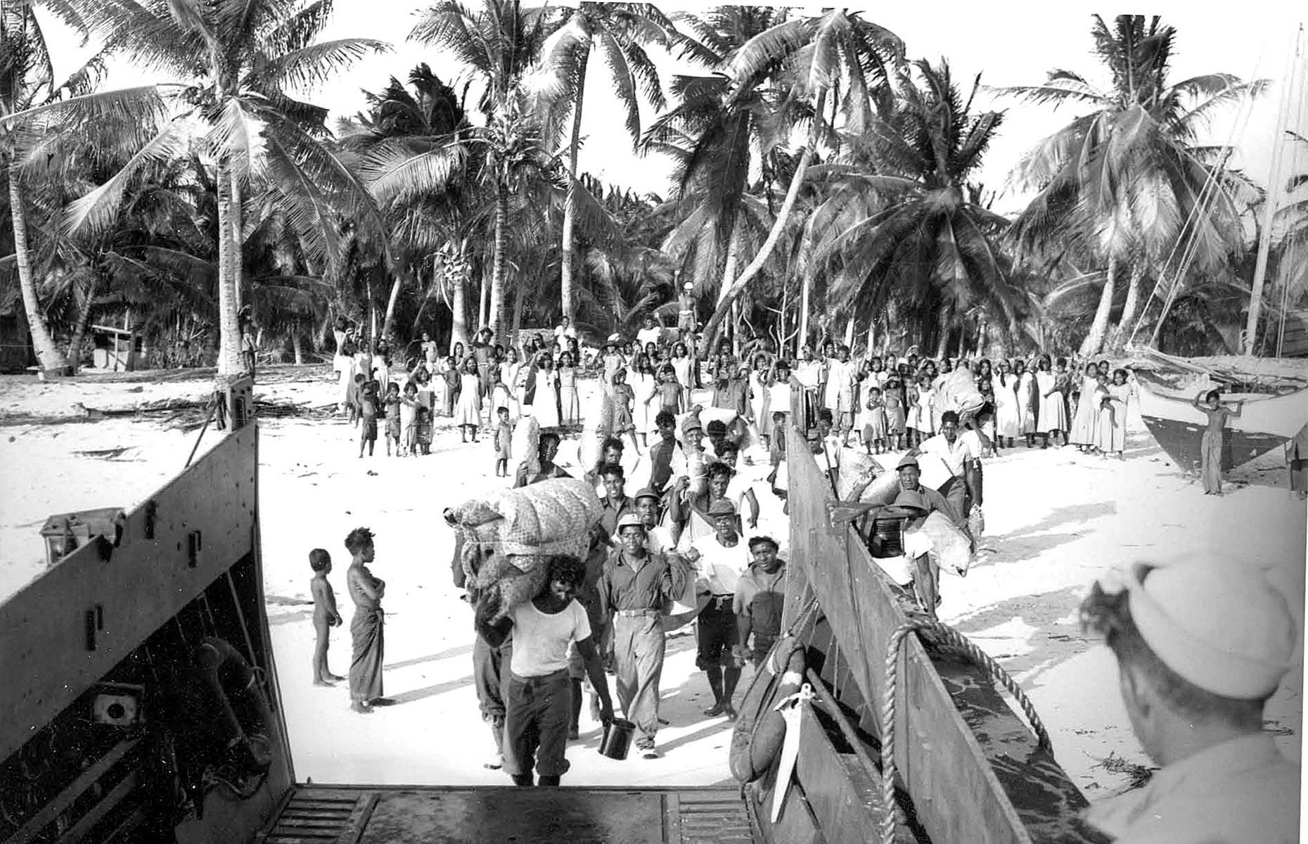 Slide 27 of 35: The islanders were evacuated (pictured here) but they were sadly never able to come back. Bikini Atoll's groundwater and soil became contaminated during the tests and it was not safe for the island's original residents to return home. Today the atoll's corals and marine life are showing signs of recovery and a few caretakers work on the island (though they must bring food and water provisions with them from elsewhere). The atoll remains otherwise deserted.