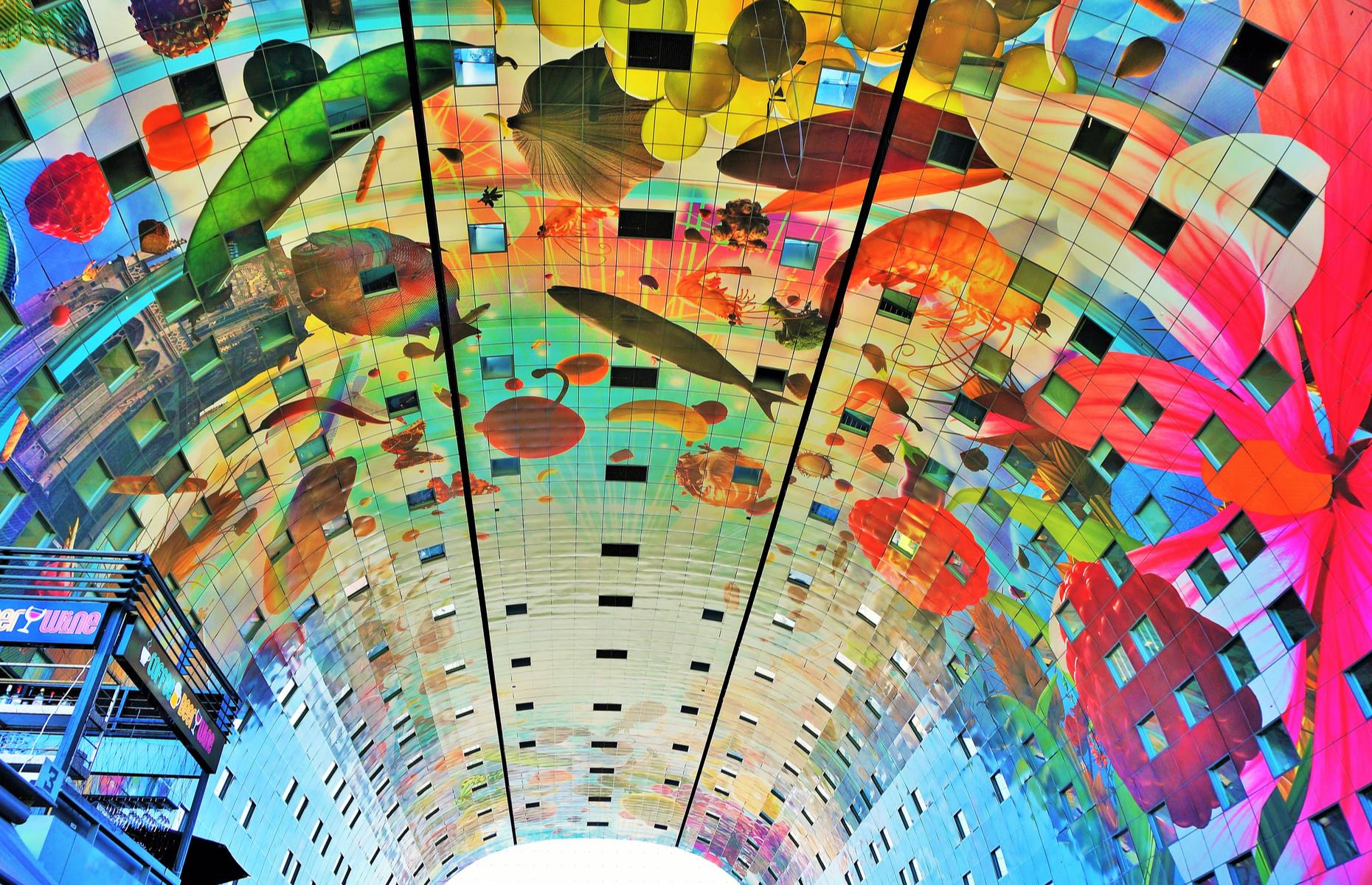 Slide 22 of 33: The gigantic and vibrant ceiling mural covering the ceiling of Rotterdam’s covered market is one the biggest artworks in the world. Cornucopia by Dutch artists Arno Coenen and Iris Roskam measures over 36,000 square feet (3,344sqm) and spans the entire interior of De Markthal. The creative port city has a wealth of bold architecture and eye-catching public art. See some of the best on a dedicated walk (face masks are compulsory).