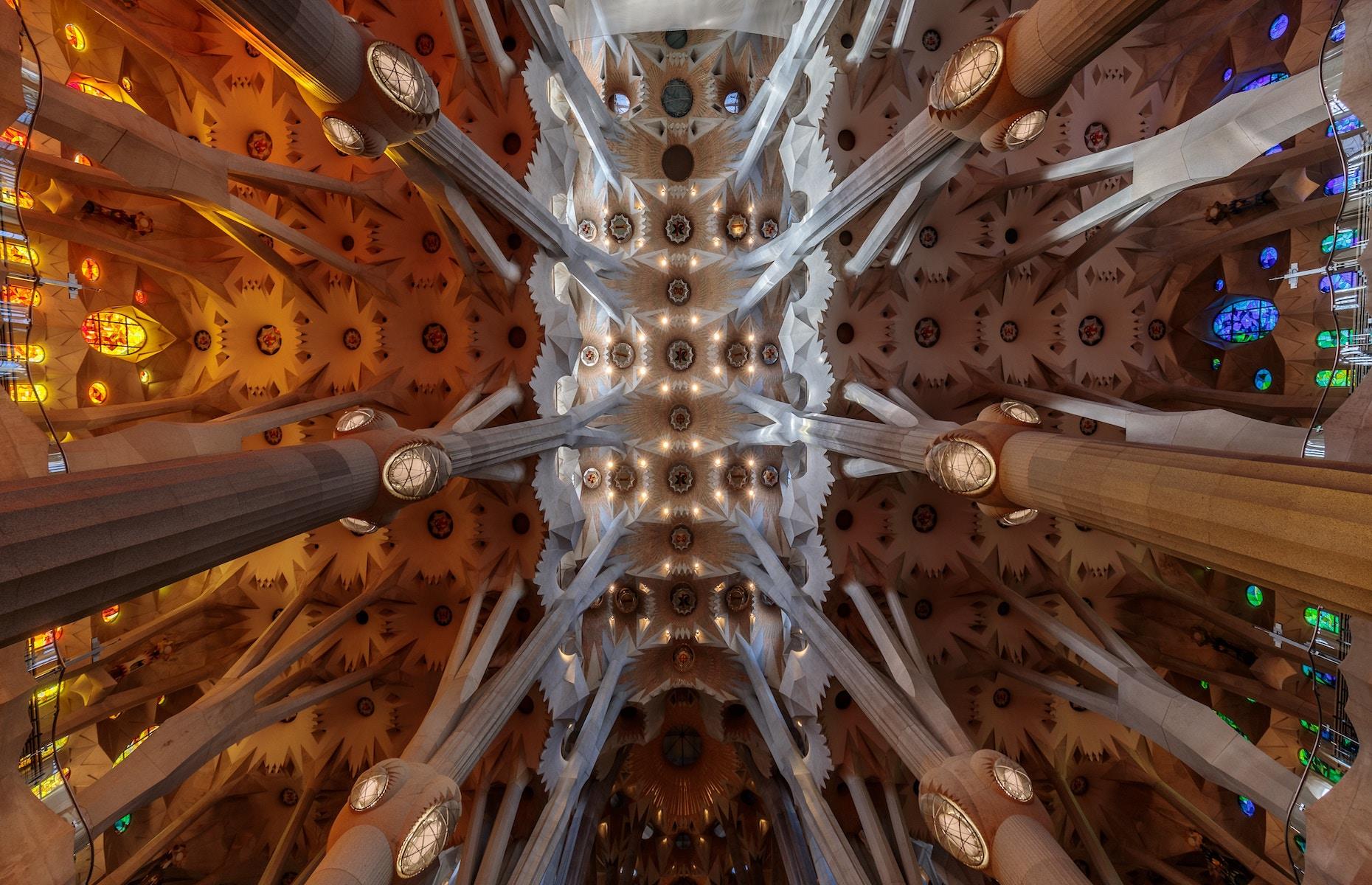 Slide 21 of 33: Antoni Gaudí’s unfinished masterpiece is a feast for the eyes. Intricate symbolism is at play throughout the building, both religious and natural, including its towering ceiling. Look up and you’ll see the dizzying forest-like design of the vast ceiling vaults. Reaching up to 200 feet (61m) in height, the columns appear like trees, branching out towards the heavens. When the basilica is complete (expected in 2026), it will be the tallest church in the world.
