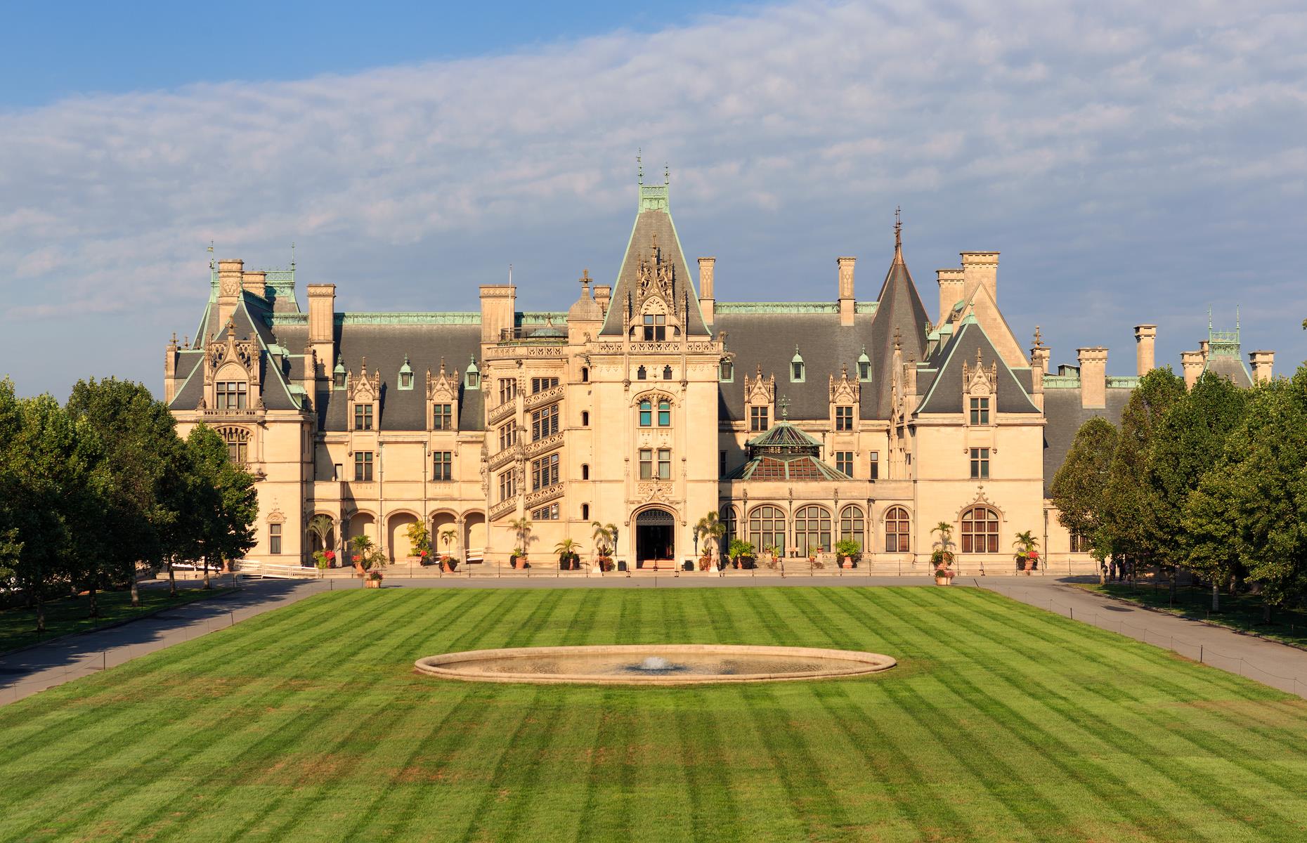 Slide 20 of 31: Touting itself as America’s largest home, Biltmore Estate is modeled on a French chateau and was completed in 1895, after six years of construction. Location is the real draw here. When young George Vanderbilt, a New York businessman from a distinguished family, visited the smoky Blue Ridge mountains, he knew he wanted to make them his backyard. Upon its completion, Biltmore Estate boasted an impressive 250 rooms, including 35 bedrooms.