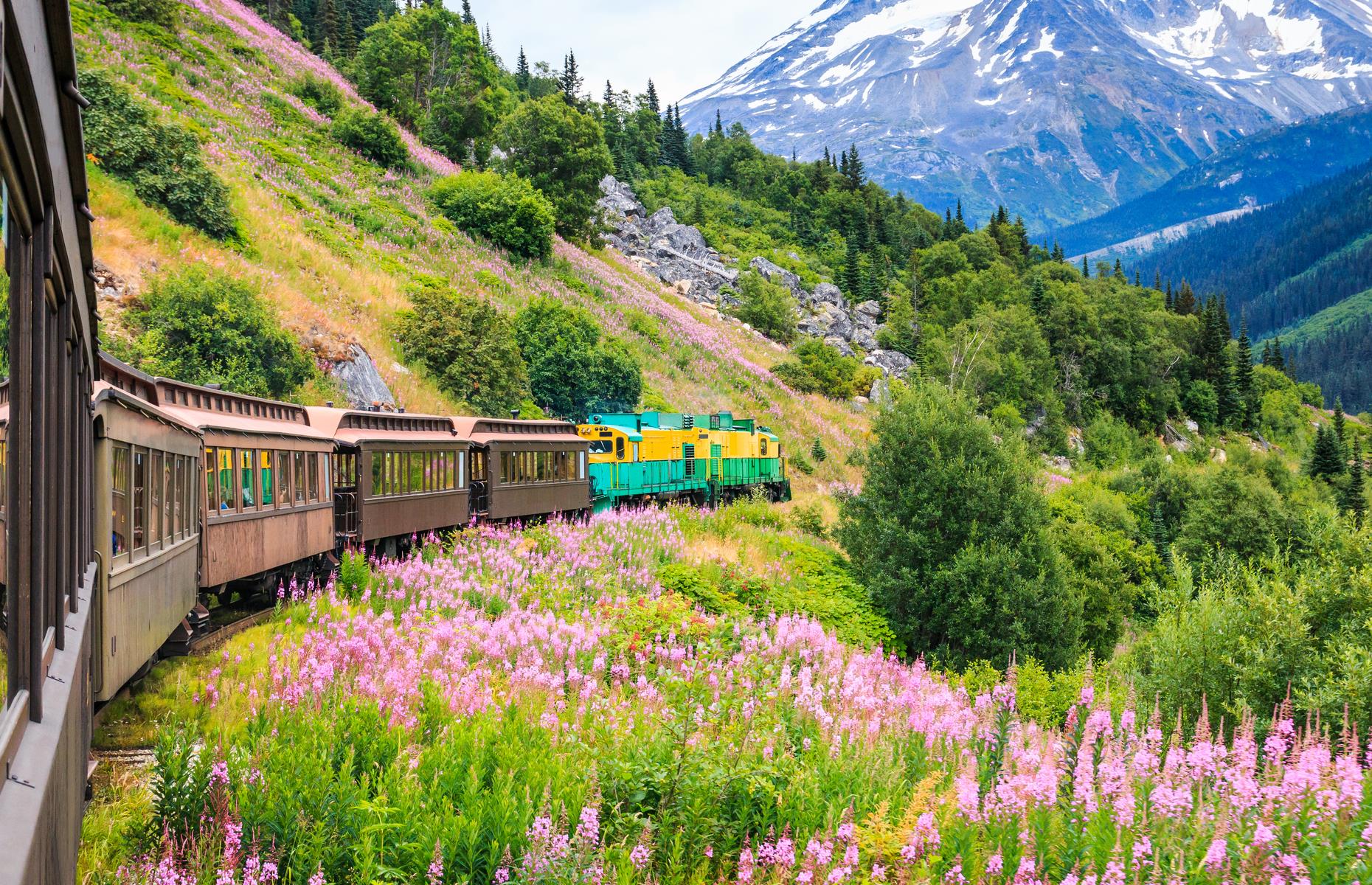 <p>This railway route touts itself as the most scenic in the world, and it's not hard to see why. The snow-dusted mountains, pink and yellow wildflowers and rambling hills appear almost Alpine. The railroad, whose construction began in 1898, instead rattles through Alaska towards Canada, leaving from the little city of Skagway. The White Pass Summit Excursion is the most traditional of routes, a 40-mile (64km) jaunt taking in the teetering peak of its namesake mountain pass. Trips look set to return during the <a href="https://wpyr.com/excursions/product/summit-excursion/">2021 season, with booking essential</a>. </p>