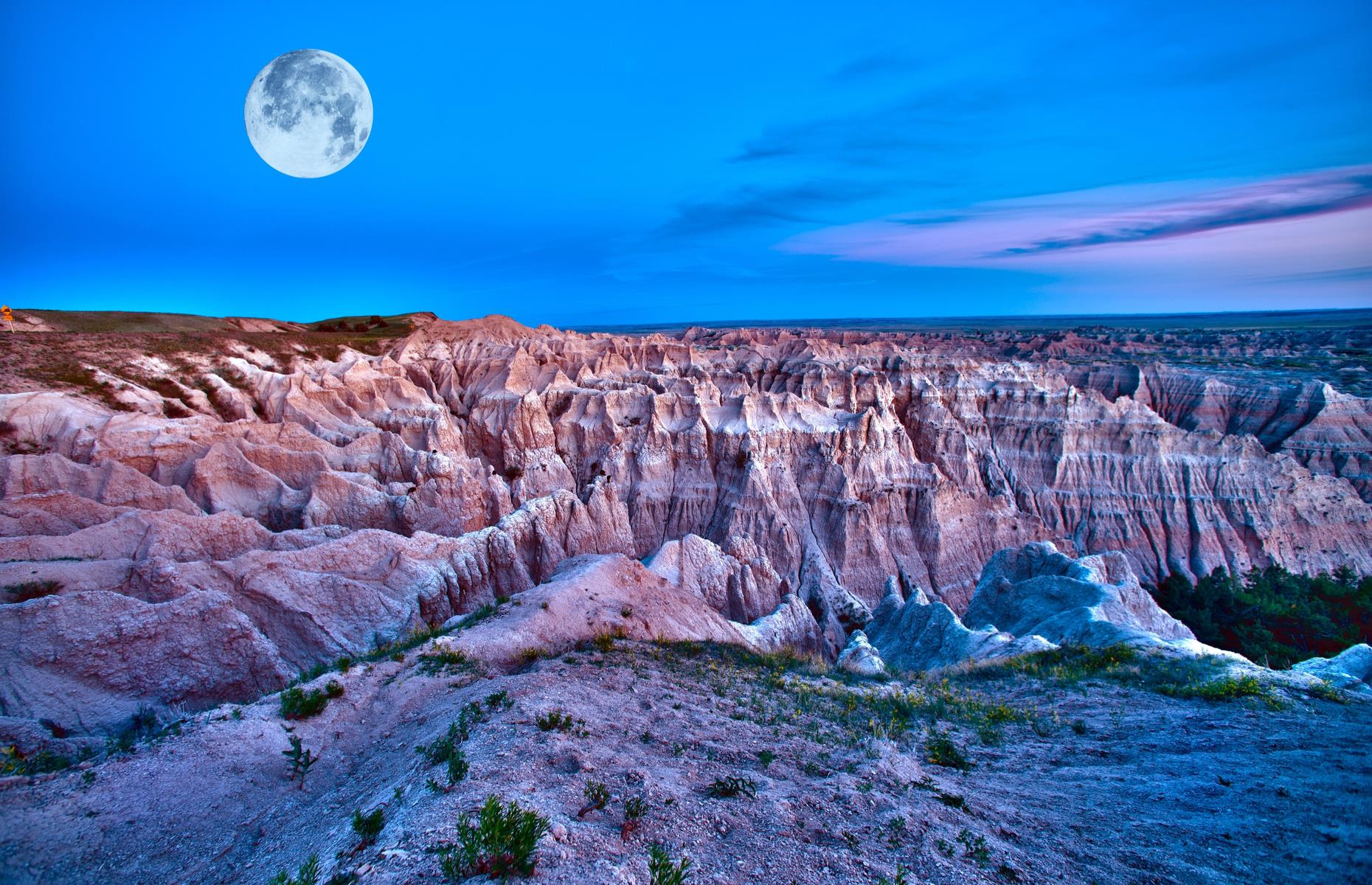 <p>It's hard to believe that these curious rock-scapes exist on this planet, let alone in the USA. Stretching over 244,000 acres, <a href="https://www.nps.gov/badl/index.htm">Badlands National Park</a> is a world of peaks and prairie, where bighorn sheep and bison roam free, and hiking trails show off the best of the landscape. Popular routes include the Door Trail, a straightforward boardwalk loop that offers fantastic views of the badlands. </p>