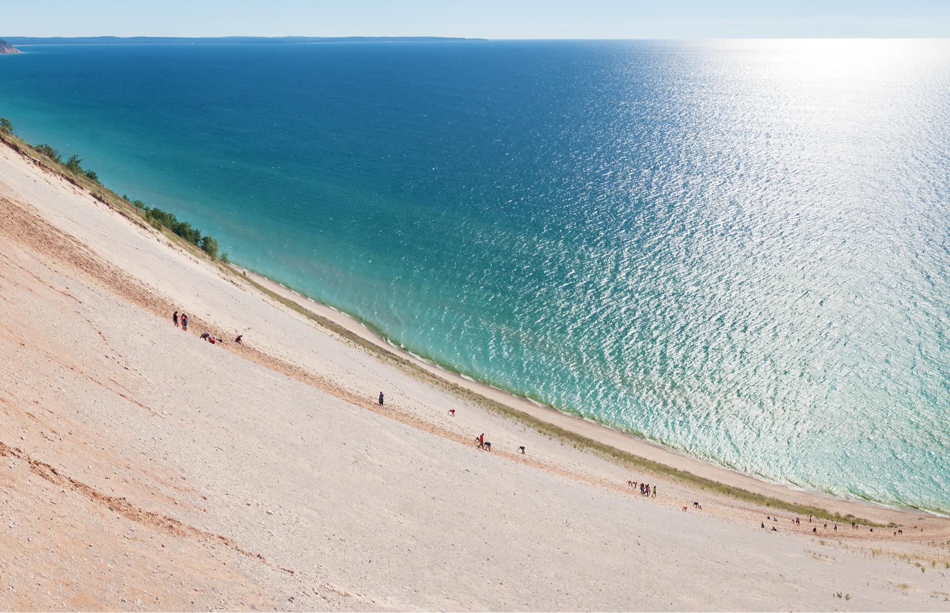 <p>Pillowy sand dunes drop down into the blue waters of Lake Michigan at this national preserve. The site protects a beautiful swathe of lakeshore in the north of Michigan's Lower Peninsula and, save for the lack of palm trees, it looks every inch the tropical paradise – not what you'd expect from the Midwest. Beyond the sandy bluffs, Sleeping Bear Dunes National Lakeshore also encompasses smaller inland lakes, shady wooded areas and a historic lighthouse. The preserve and beaches are open but some facilities are closed so please <a href="https://www.nps.gov/slbe/planyourvisit/conditions.htm">check before heading out</a>. </p>