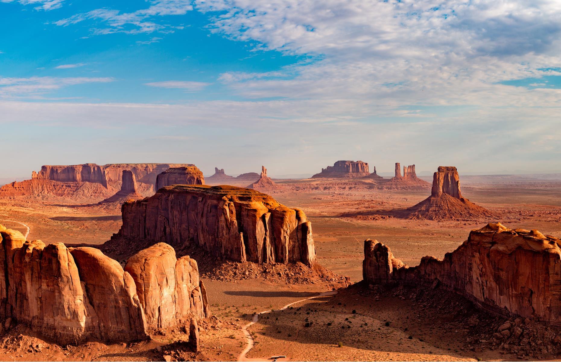 The famous coppery buttes of Monument Valley are synonymous with the southwest USA and the image of the American West. The red rockscape, 30,000 acres of which is protected as a Navajo Tribal Park, is located on the Arizona and Utah state border. The imposing buttes rise up as high as 1,000 feet (305m) above the valley floor.