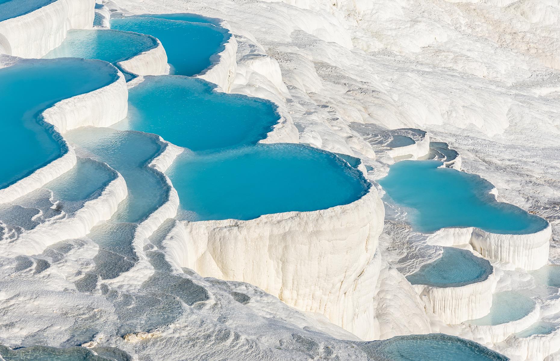 <p>One of Turkey’s most beautiful sights, the surreal travertine terraces of Pamukkale (meaning 'cotton castle') are a geological phenomenon. The striking pools are a result of the mineral-rich hot springs that bubble away beneath the ground. Here are more of <a href="https://www.loveexploring.com/galleries/92672/the-worlds-most-beautiful-natural-wonders?page=1">the world's most beautiful natural wonders</a>.</p>
