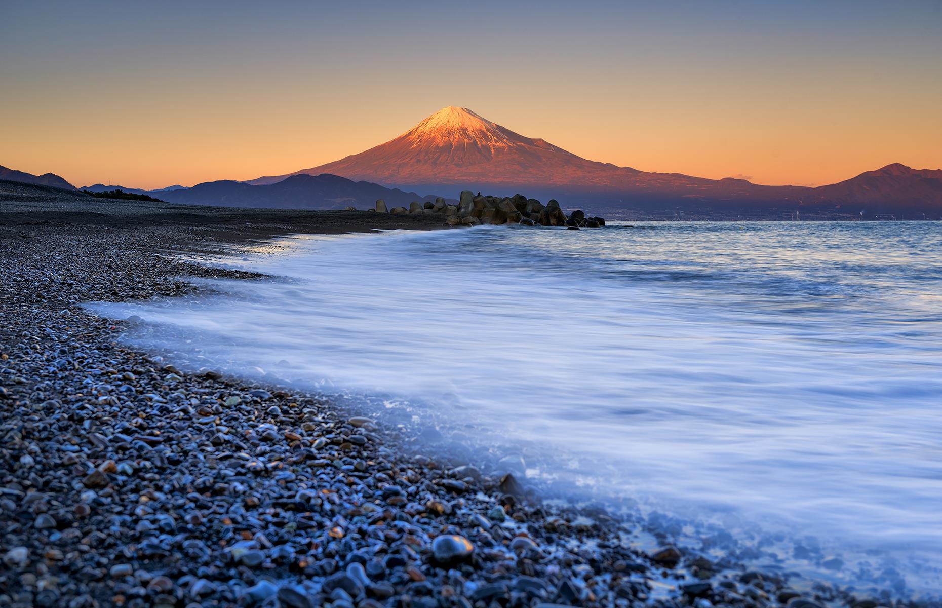 <p>A serene four-mile-long (7km) pine-lined shoreline with Mount Fuji rising tall in the distance, Miho no Matsubara is regarded as one of Japan's most beautiful sights and was designated a National Place of Scenic Beauty of Japan in 1922. It is also the location of a legend that says a celestial being was overwhelmed by the beauty of the bay, so she took off her robe to bathe in the water. A local fisherman saw her and refused to give back her robe until she performed a dance for him. A statue of the fisherman watching the dance now stands at the entrance of the park.</p>