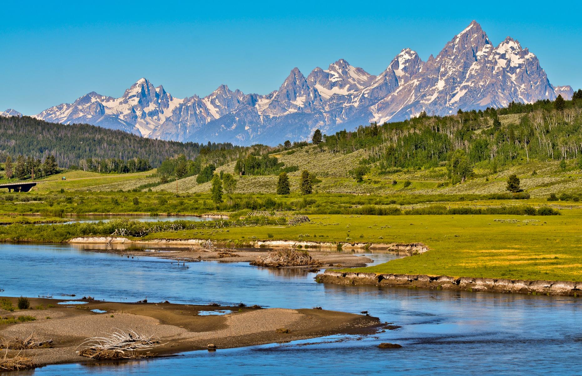 Slide 13 of 32: The vast landscape of Grand Teton National Park is etched with snow-capped mountains, woodland and crystalline lakes. The highlight of the dramatic scenery is the Teton mountain range, of which the park's namesake Grand Teton is the highest.