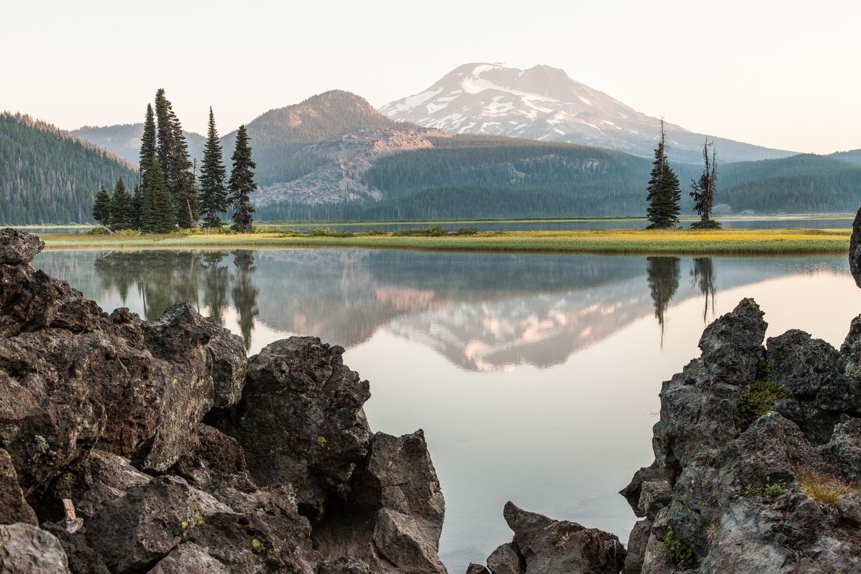 <p><b>Oregon</b><br><a href="https://www.fs.usda.gov/recarea/deschutes/recarea/?recid=71876">Sparks Lake</a> is home to one of the country's most unique ecosystems. The park includes 370 acres of lake wetland that is surrounded by a roughly equal number of acres of stream wetlands, marsh, or meadows. The result is a bird watcher's or wildlife photographer's paradise. In the background are the Bachelor Butte, Broken Top, and South Sister mountain peaks, all of which soar above 9,000 feet.</p>