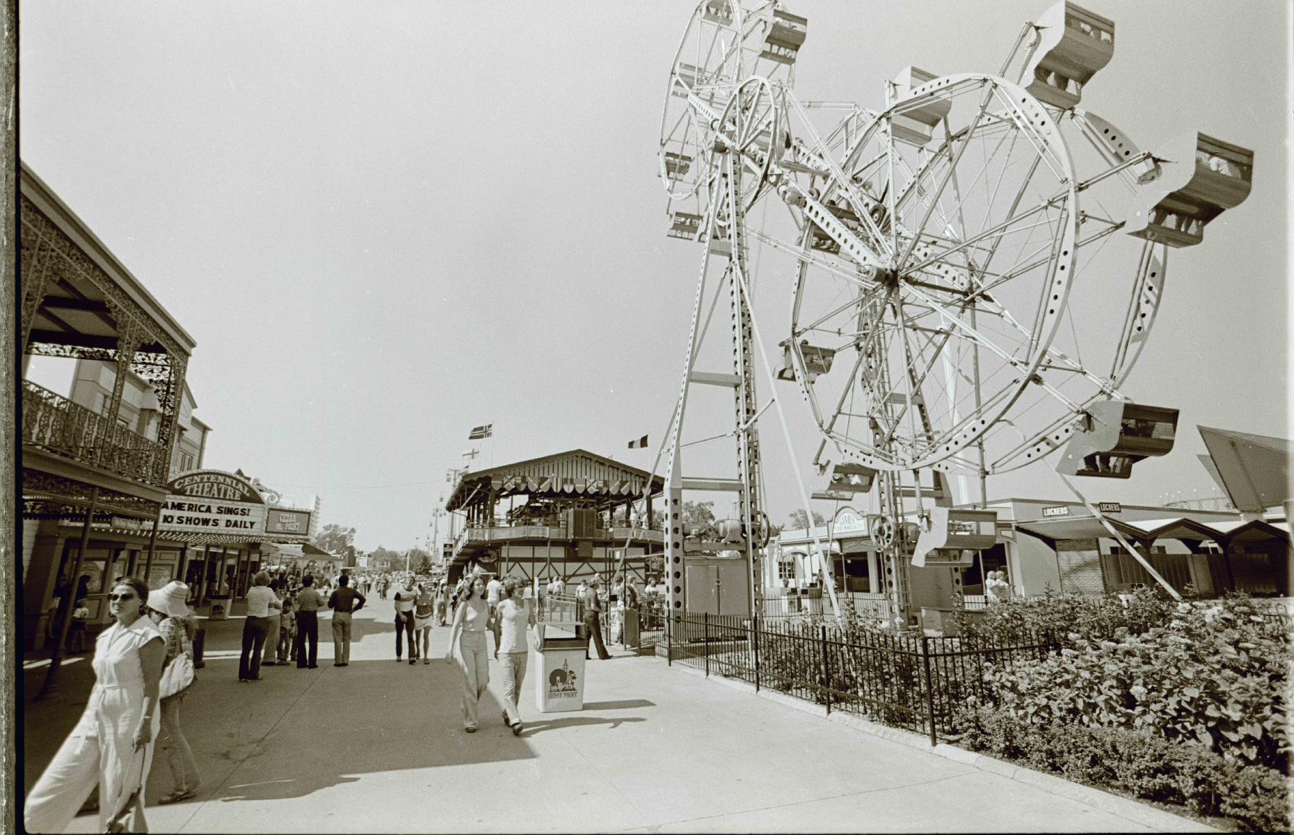 Slide 14 of 35: Even today much of the action happens on the Main Midway (pictured), one of the oldest parts of the park. Cedar Point's Giant Sky Wheel, a vast double Ferris wheel (pictured right) debuted in the 1960s and delighted visitors right up until 1980. Meanwhile, the Centennial Theater (pictured back left) continues to entertain audiences as the Jack Aldrich Theater today.
