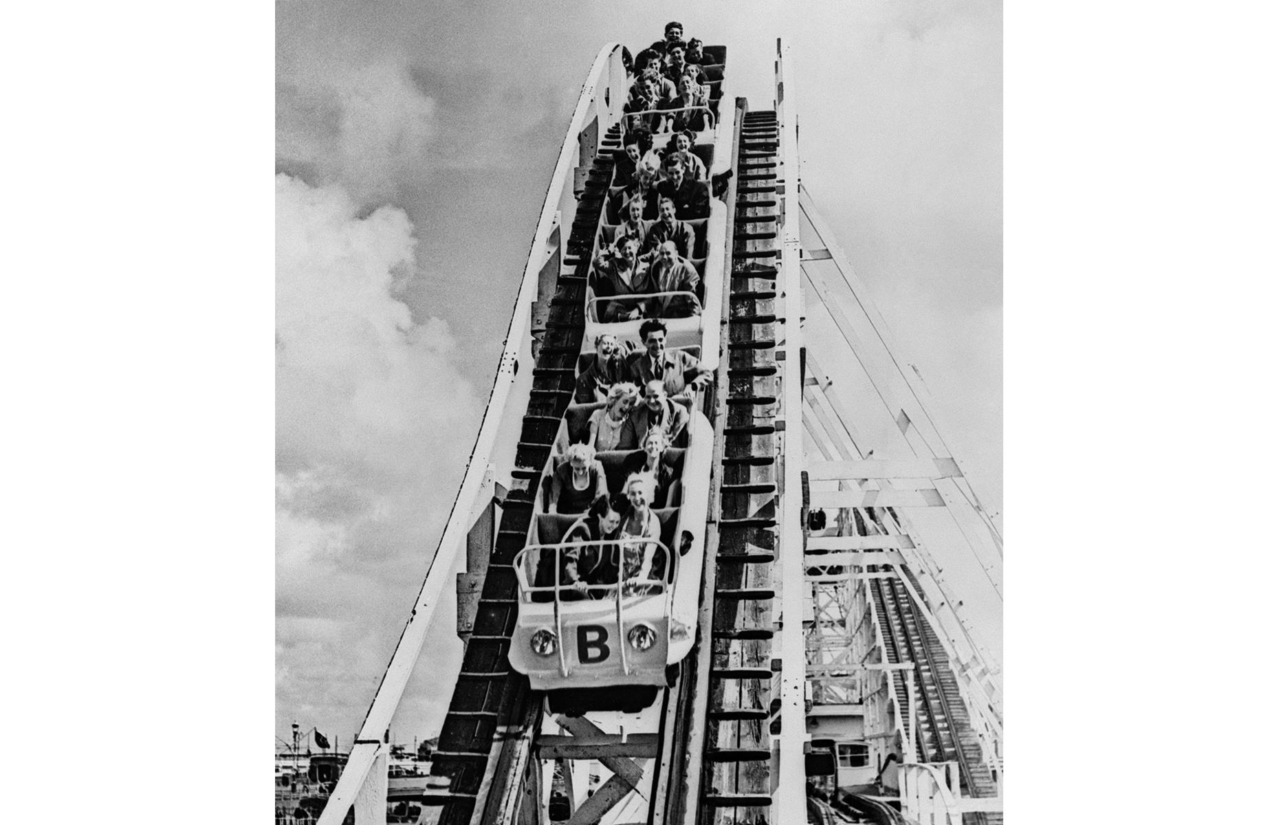 Slide 5 of 35: The tourist attraction is still going strong, and the Big Dipper, a wooden coaster first installed in the 1920s, is one ride that has become synonymous with the park. Here visitors in the 1950s brave one of the Dipper's epic drops.