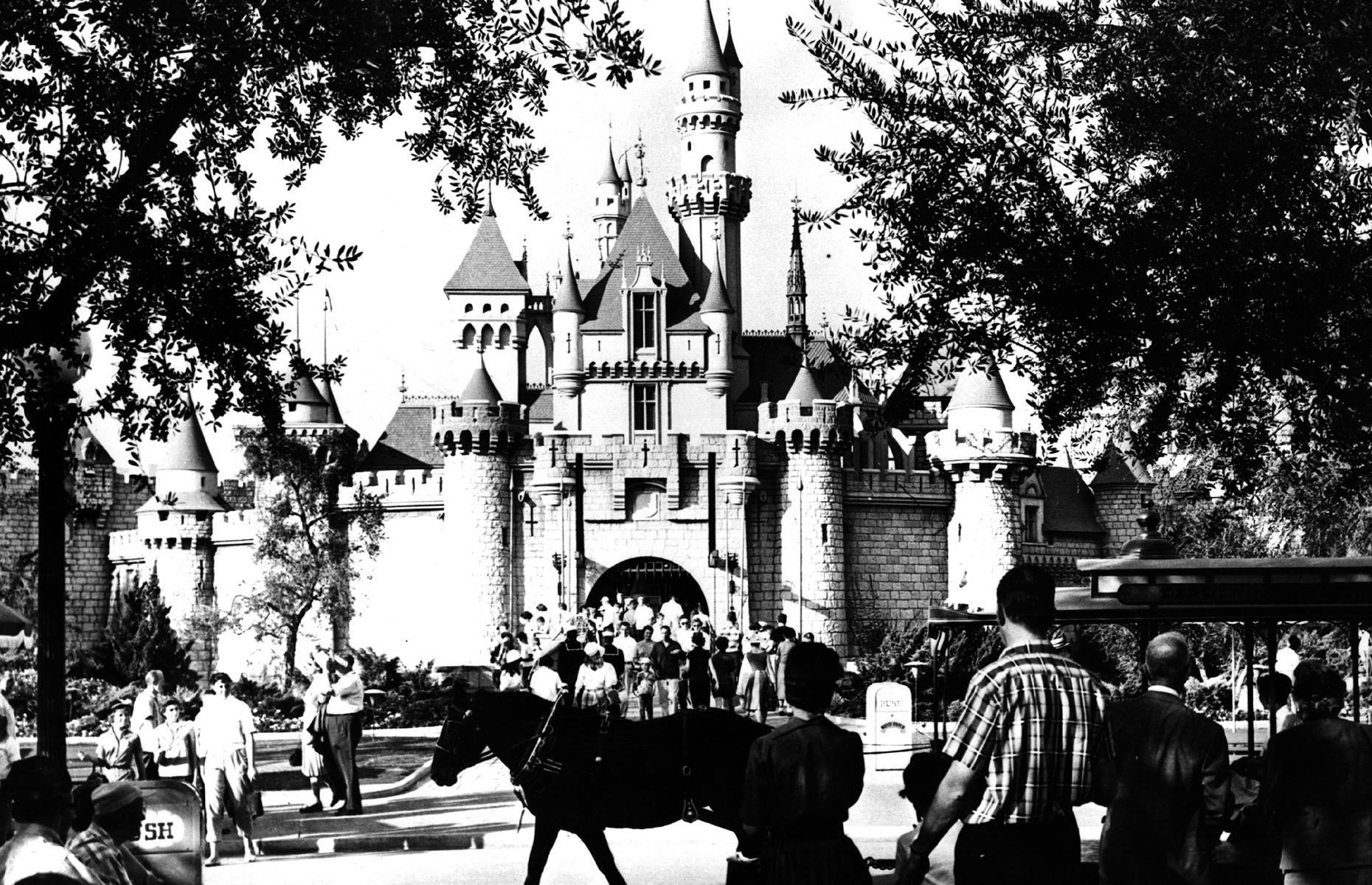 Slide 31 of 35: Perhaps no theme park image is more iconic today than Disneyland California's Sleeping Beauty Castle – and she looked just as beautiful in the 1960s, when this snap was taken. Created in the image of Germany's Neuschwanstein Castle, the structure was one of Disneyland's (now Disneyland Park) earliest attractions. Here park-goers drink in the castle's impressive towers and turrets.