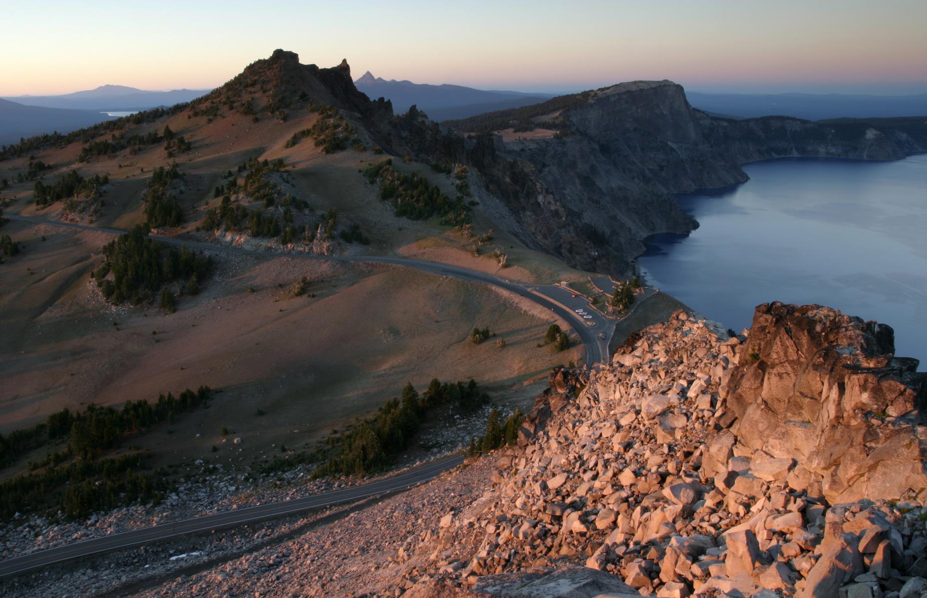 <p>Crater Lake is the deepest lake in the US and also <a href="https://www.loveexploring.com/gallerylist/87438/americas-most-stunning-lakes">one of the most breathtakingly gorgeous</a>. And this 33-mile (53km) highway allows you to gaze upon its beauty from every angle. It loops around the caldera rim of the sapphire lake, with several <a href="https://www.nps.gov/crla/planyourvisit/overlooks.htm">overlooks and pullouts</a> for perfect views of forested islands, flower-strewn slopes and craggy rock formations.</p>