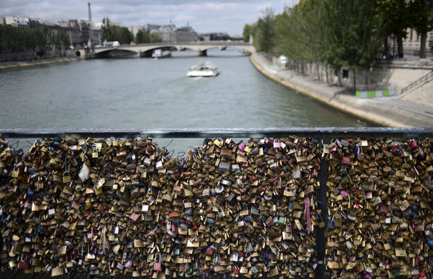 Slide 26 of 39: This quirky tradition saw tourists flocking to the City of Love to express their amor by signing theirs and their partner's names on padlocks, before attaching them to the Pont des Arts over the River Seine. The practice became so popular that at one point the bridge contained one million padlocks weighing around 45 tons.