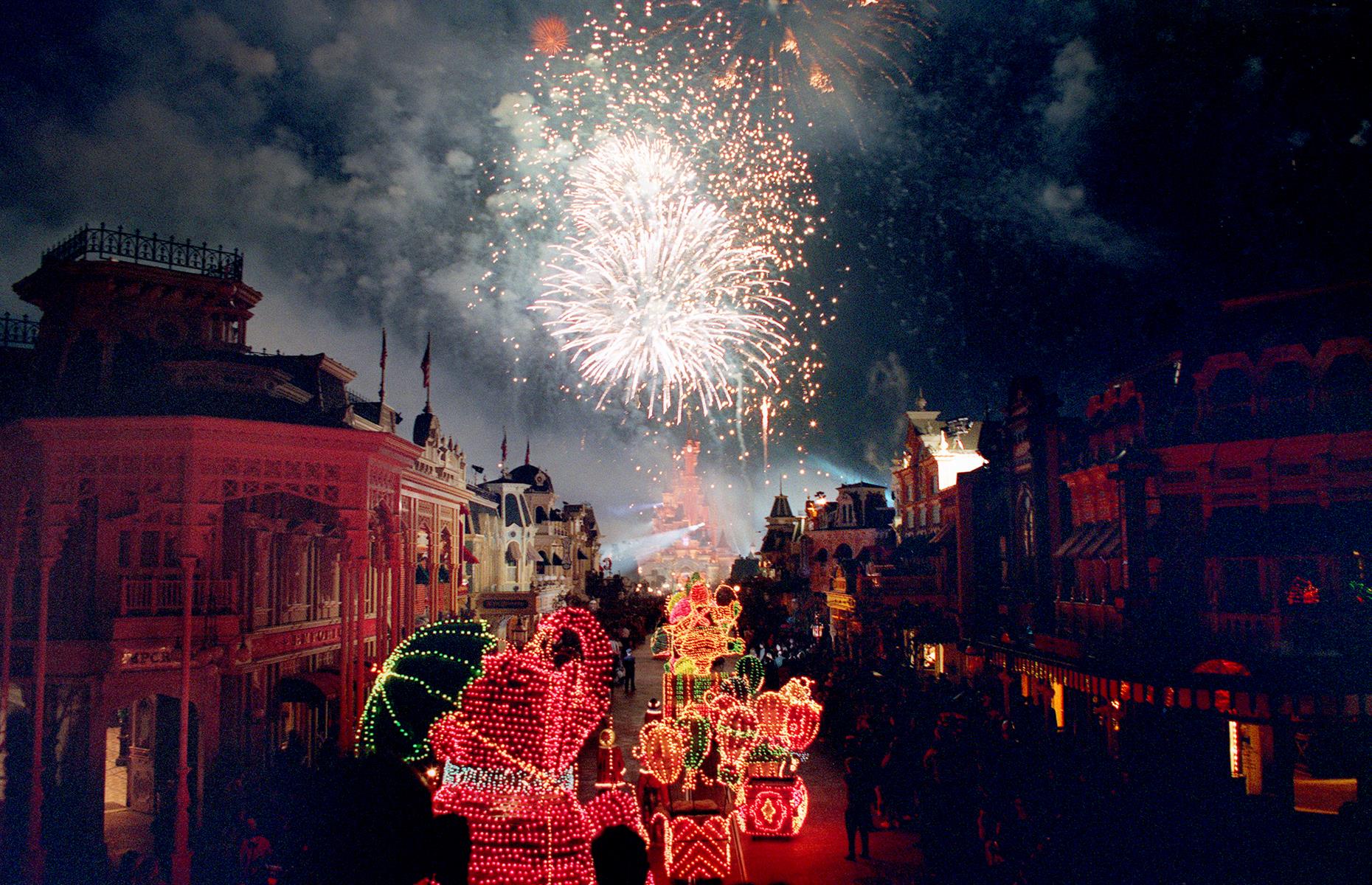 The final hours of Euro Disney's opening day went with a bang. Fireworks glittered over the new park and floats bright with lights passed in a parade through Main Street.