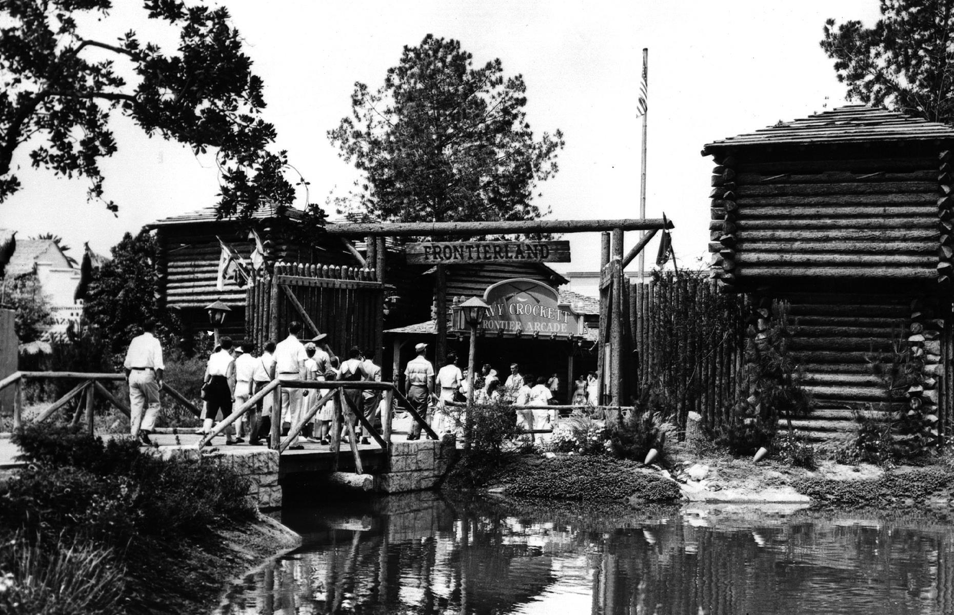 Slide 9 of 38: California's Disneyland opened with five enchanting "lands", and versions of each are still present today. These were Adventureland, Fantasyland, Tomorrowland, Main Street, U.S.A and Frontierland, the entrance to which is pictured here in 1955. Frontierland was designed to evoke America's Old West with early attractions including a horse-drawn Conestoga wagon and stagecoach and the Golden Horseshoe Saloon.
