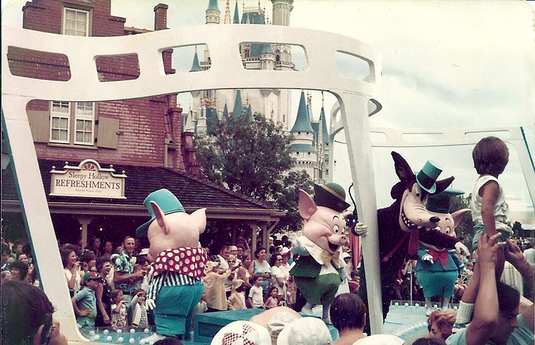Just five years after Florida's Magic Kingdom opened, America celebrated its bicentennial – and, in true Disney style, the theme park marked the special occasion with parties and parades. Here children and adults look on in awe as a float carrying the Three Little Pigs and the Big Bad Wolf glides through the streets.