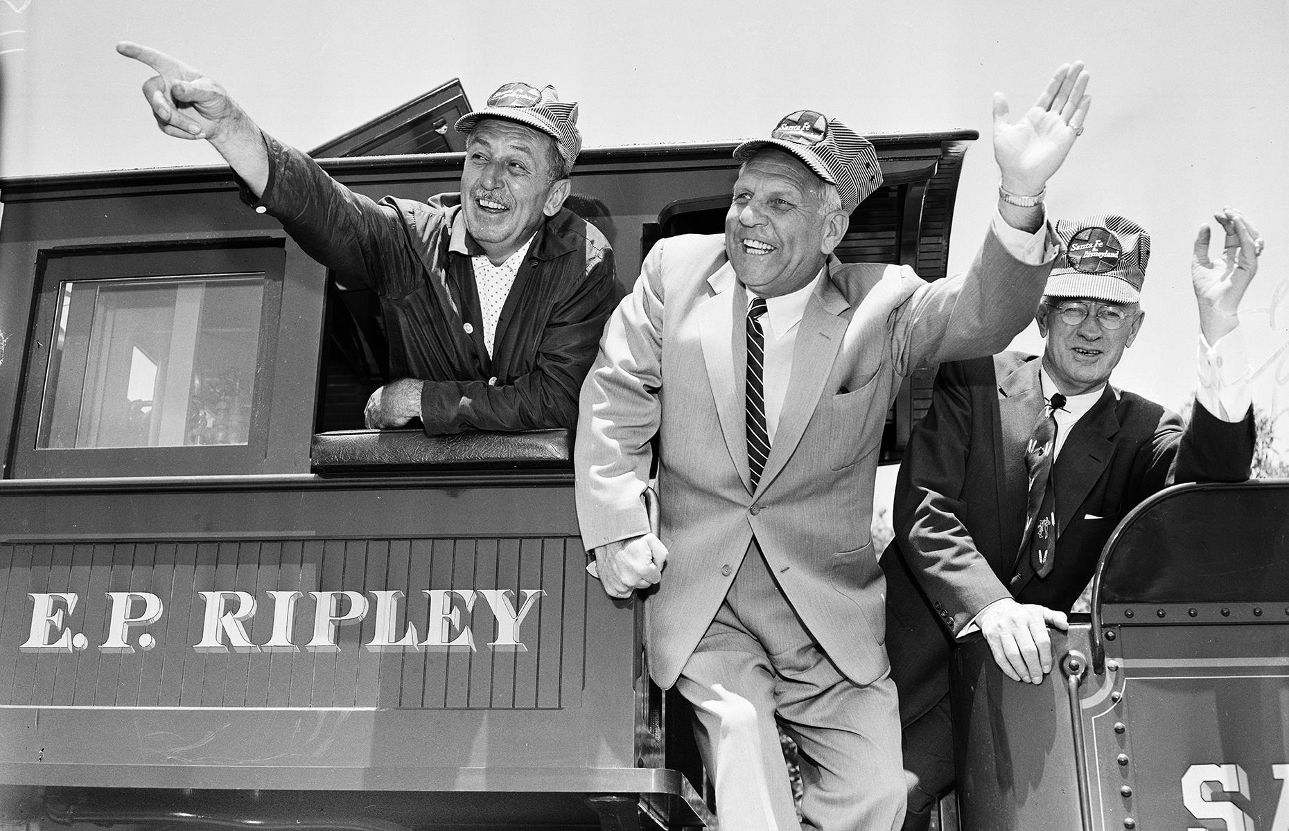 Slide 7 of 38: On the opening day, Walt Disney could hardly contain his joy as he showed California dignitaries around the park. He's snapped here riding the beloved Disney steam locomotive E. P. Ripley, as he gleefully points out the sights to then-state governor Goodwin Knight (pictured middle).