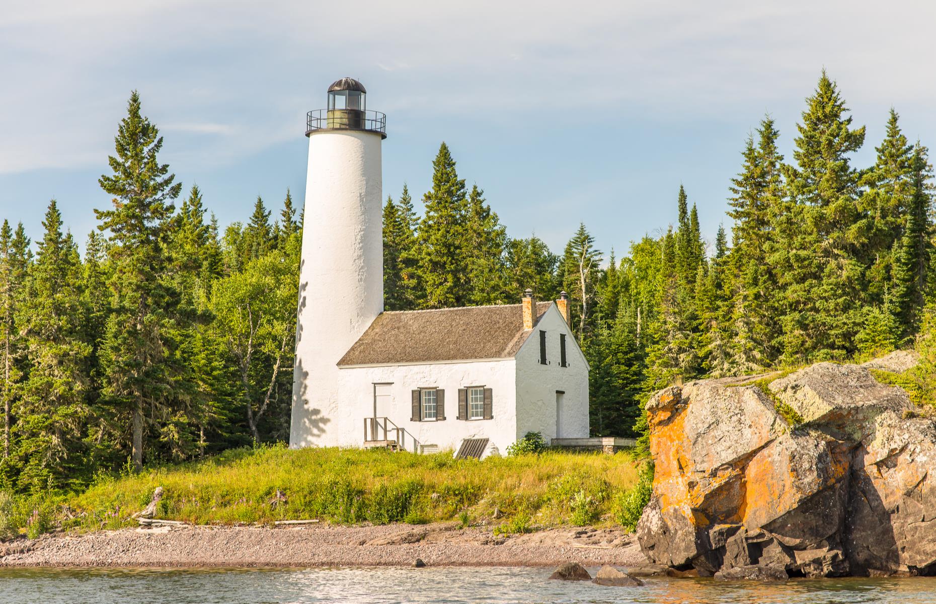 Slide 34 of 100: Floating in the waters of Lake Superior – one of the largest freshwater lakes in the world – Isle Royale National Park protects a tranquil archipelago covered with forests and bustling with wildlife. Its man-made wonders include the striking Rock Harbor Lighthouse – perched on its namesake, Rock Harbor, the landmark dates back to the 1850s. Discover more of America's amazing lighthouses.