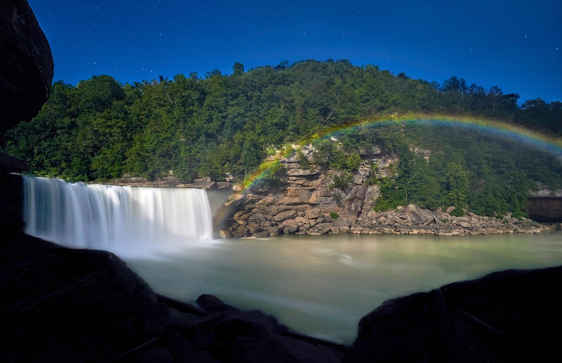 Slide 26 of 100: One of Kentucky's top natural wonders, Cumberland Falls plunges down for 68 feet (21m) and spools out to a width of 120 feet (37m). But its very respectable size isn't what makes the waterfall truly special. It's also known for its moonbows – spectacular nighttime rainbows that show up on clear nights.