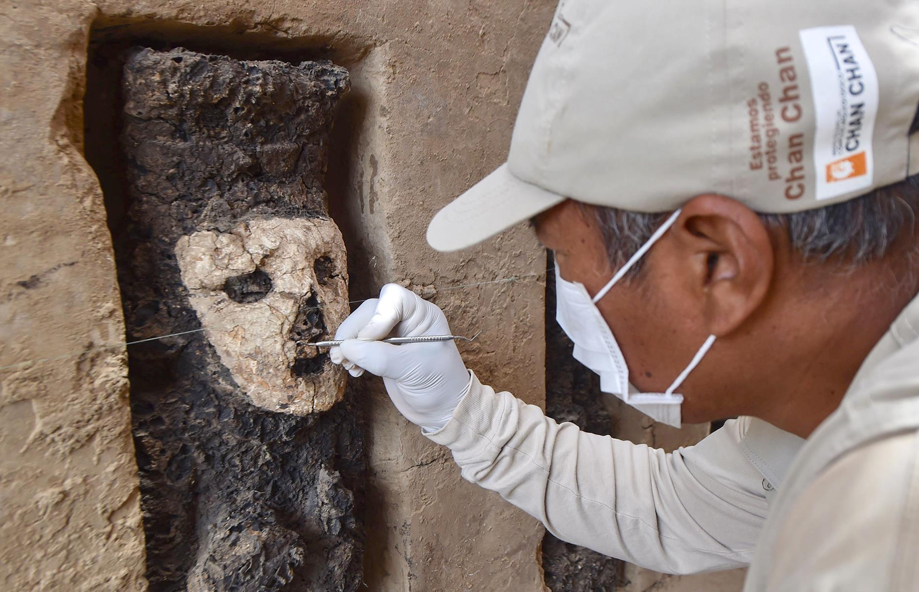 Slide 8 of 50: An intricate adobe wall and some 19 wooden statues were discovered on the site at the end of 2018. It's thought that the structures were buried around 750 years ago and each one stands around 26 inches (70cm) tall, cast in wood, with a simple clay mask. The figures also seem to wield both a scepter and a shield. Experts believe the statues could have served as "guardians" and excavation work is set to continue.