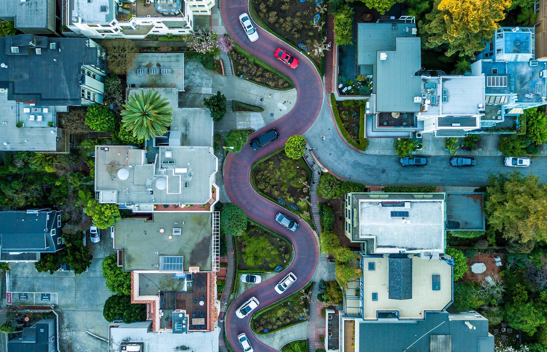 Slide 4 of 45: People are fascinated by San Francisco's steep slopes and windy roads, and the twists and turns of this particular street look even more pronounced from up high. Fondly nicknamed Crooked Street, this is a stretch of Lombard Street whose eight super-tight hairpin bends pose a big challenge for modern drivers. The street was initially built this way to allow early automobiles to travel down the steep hill safely.