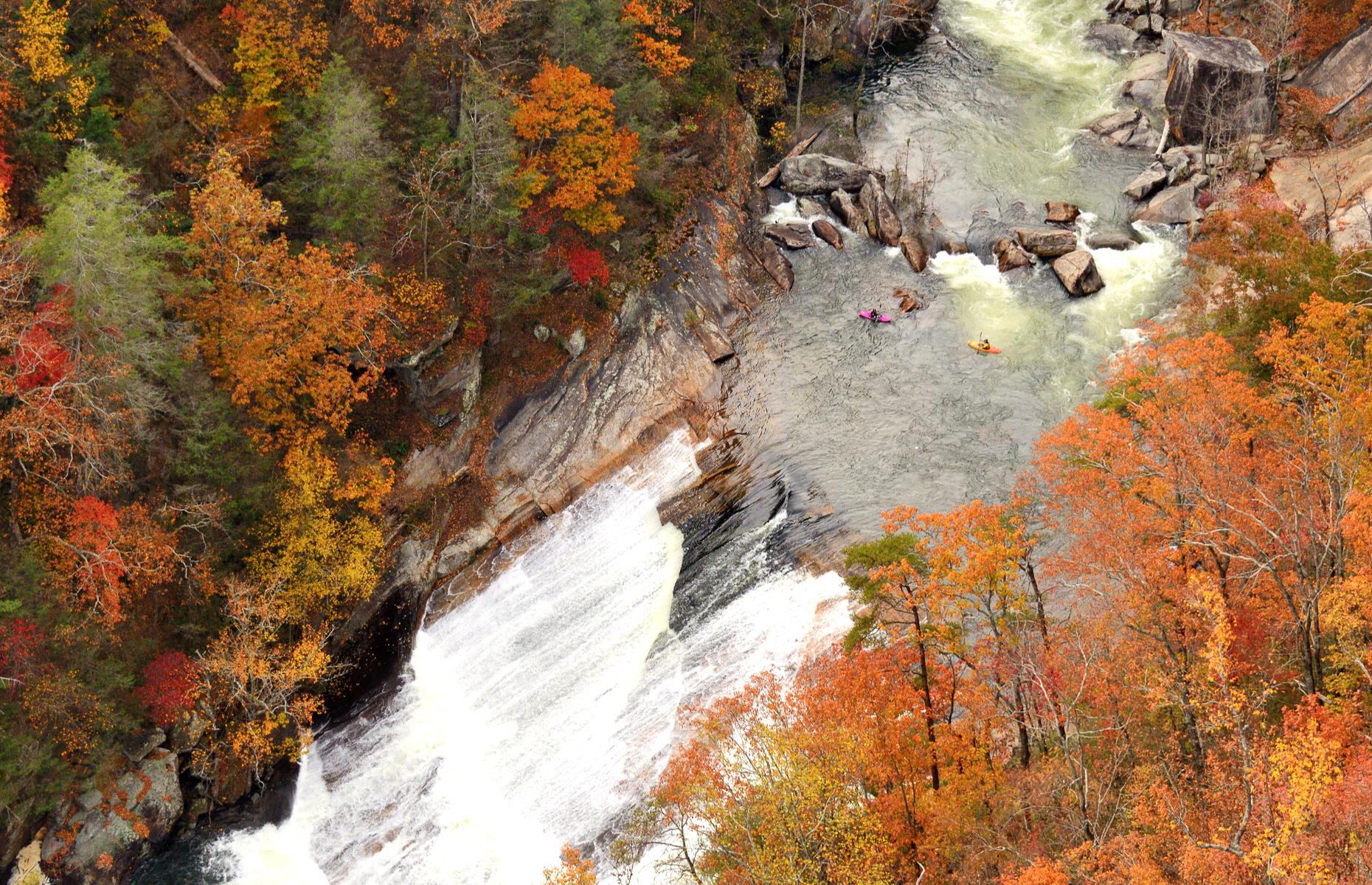 Slide 11 of 45: Tallulah Gorge State Park is a beautiful natural preserve in Georgia's Rabun and Habersham counties. While it's a scenic area year round, the park truly comes into its own in the fall when the gorge's plunging walls are topped with fiery foliage. Here adventurous kayakers, appearing like colorful ants from the air, enjoy the rushing Tallulah River.