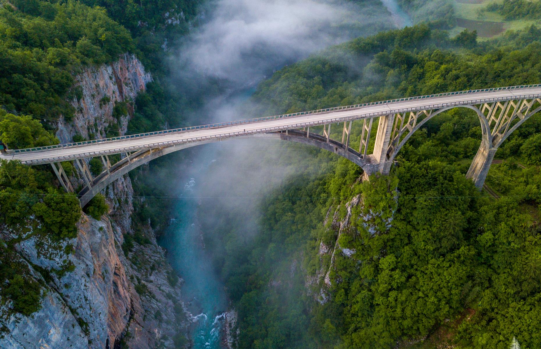 <p>Spanning the Tara River in northern Montenegro, historic Djurdjevica bridge is one of the country's most spectacular sights and a wonder to drive across. Gaze across at the hills, river and at the gaping canyon below. The lofty arched bridge was built between 1939 and 1940 and was the biggest vehicular concrete arch bridge in Europe when it was completed. During the Second World War the central arch was detonated to halt the Italian invasion. It was rebuilt in 1946. Discover more of <a href="https://www.loveexploring.com/galleries/65671/29-of-the-worlds-most-beautiful-bridges?page=1">the world's most beautiful bridges here</a>. </p>