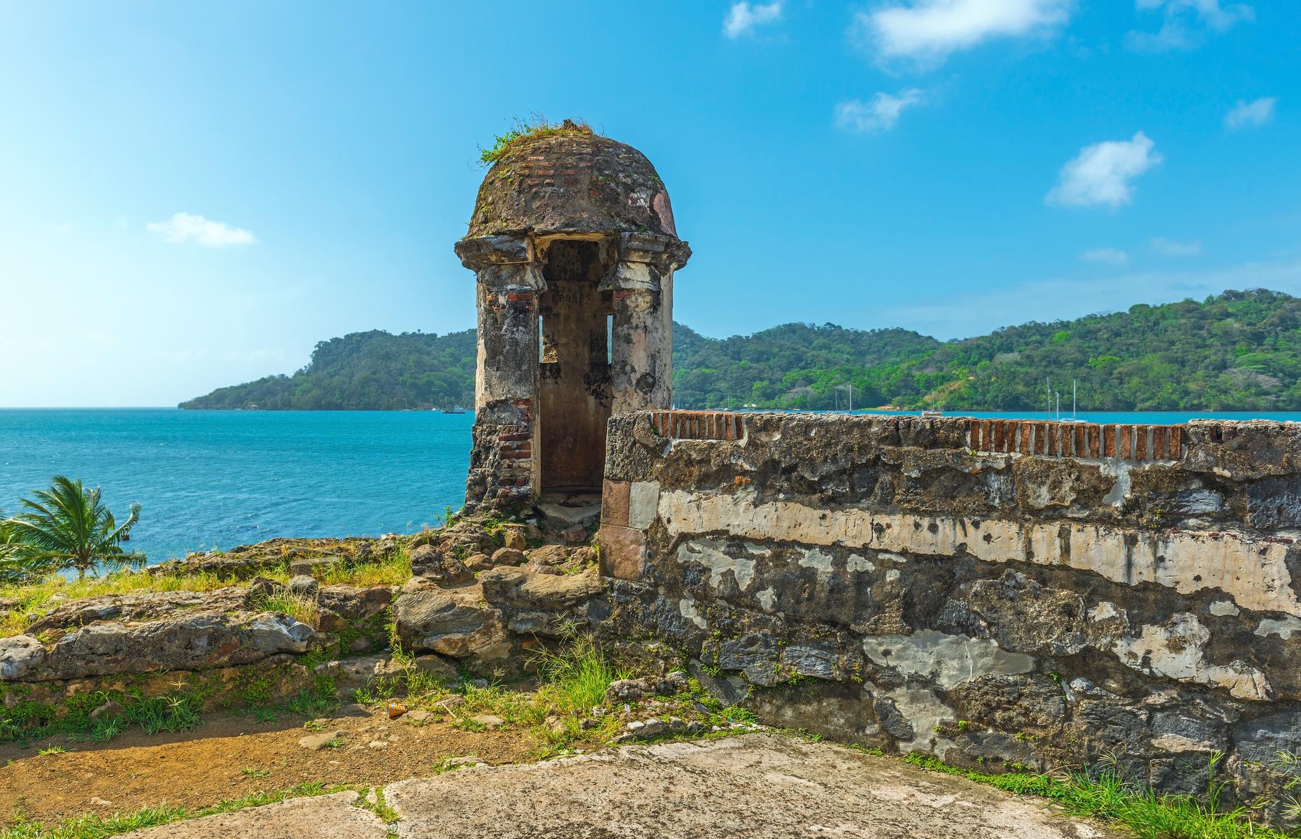 Slide 35 of 53: The 17th and 18th-century military fortifications on Panama’s Caribbean coast are described as: “a masterpiece of human creative genius” by UNESCO. They formed part of a defense system built by the Spanish crown to protect transatlantic trade. Portobelo was a major Caribbean port and played a leading role in controlling the imperial trade in the Americas. It’s been deemed as at risk since 2012 due to a variety of environmental factors, as well as uncontrolled urban sprawl and development and a lack of maintenance and management.