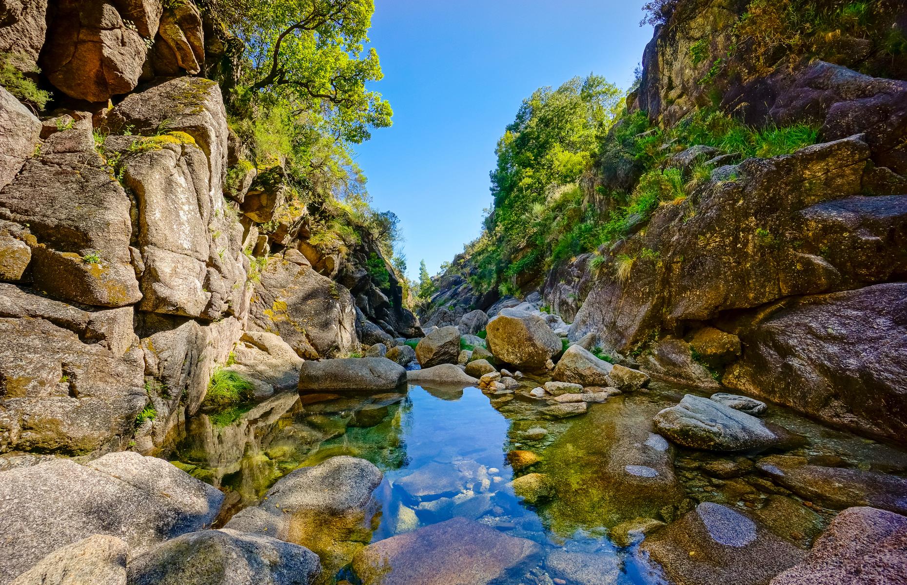 <p>In northern Portugal near the Spanish border lies the 271-square-mile (702sq km) Peneda-Gerês National Park, full of vast, stony landscapes, oak forests and glimmering mountain creeks. Established in 1971, it's just over an hour's drive from the charming city of <a href="https://www.loveexploring.com/guides/78179/explore-porto-the-top-things-to-do-where-to-stay-and-what-to-eat">Porto</a>. The rich array of wildlife includes wild ponies, wolves, otters, plus 15 species of bat (including 10 that are endangered).</p>