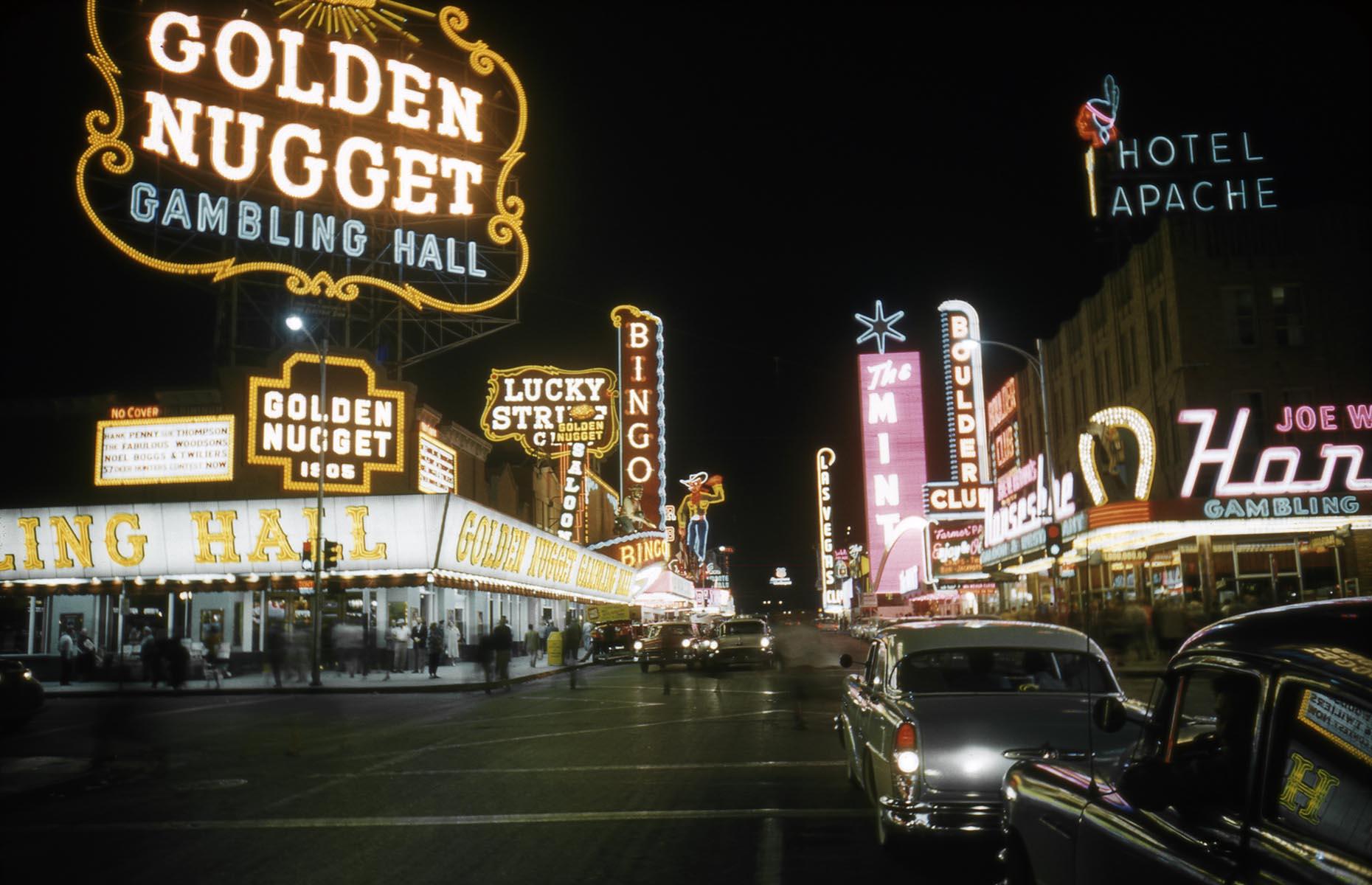 Slide 15 of 34: One of the oldest Las Vegas hotel-casinos still around today, Golden Nugget first opened its doors in 1946. Its massive neon sign instantly became an icon of Fremont Street (pictured here in 1958) and along with The Apache Hotel, El Cortez and The Mint, it became known as the Glitter Gulch thanks to the tall neon signs looming over the narrow street. The hotel has been featured on the big screen several times, including Elvis Presley's Viva Las Vegas and Diamonds Are Forever. Now check out these abandoned movie sets time forgot.