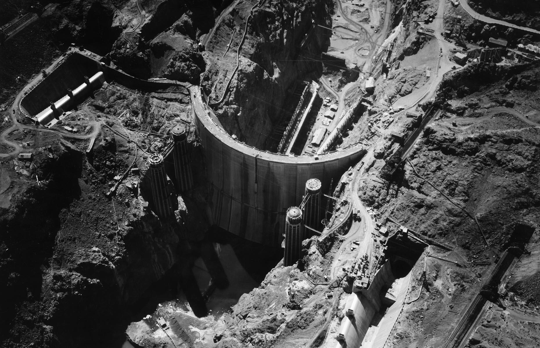 Slide 9 of 34: The construction of the Hoover Dam is still probably the most significant development in the city's history. Its construction brought in new residents (and gamblers) and it gave the valley's economy a much-needed boost during the Great Depression. It also provided two key commodities in ample supply – water and electricity. Finished in 1936, it's still one of the largest and most ambitious public works ever undertaken by the federal government.