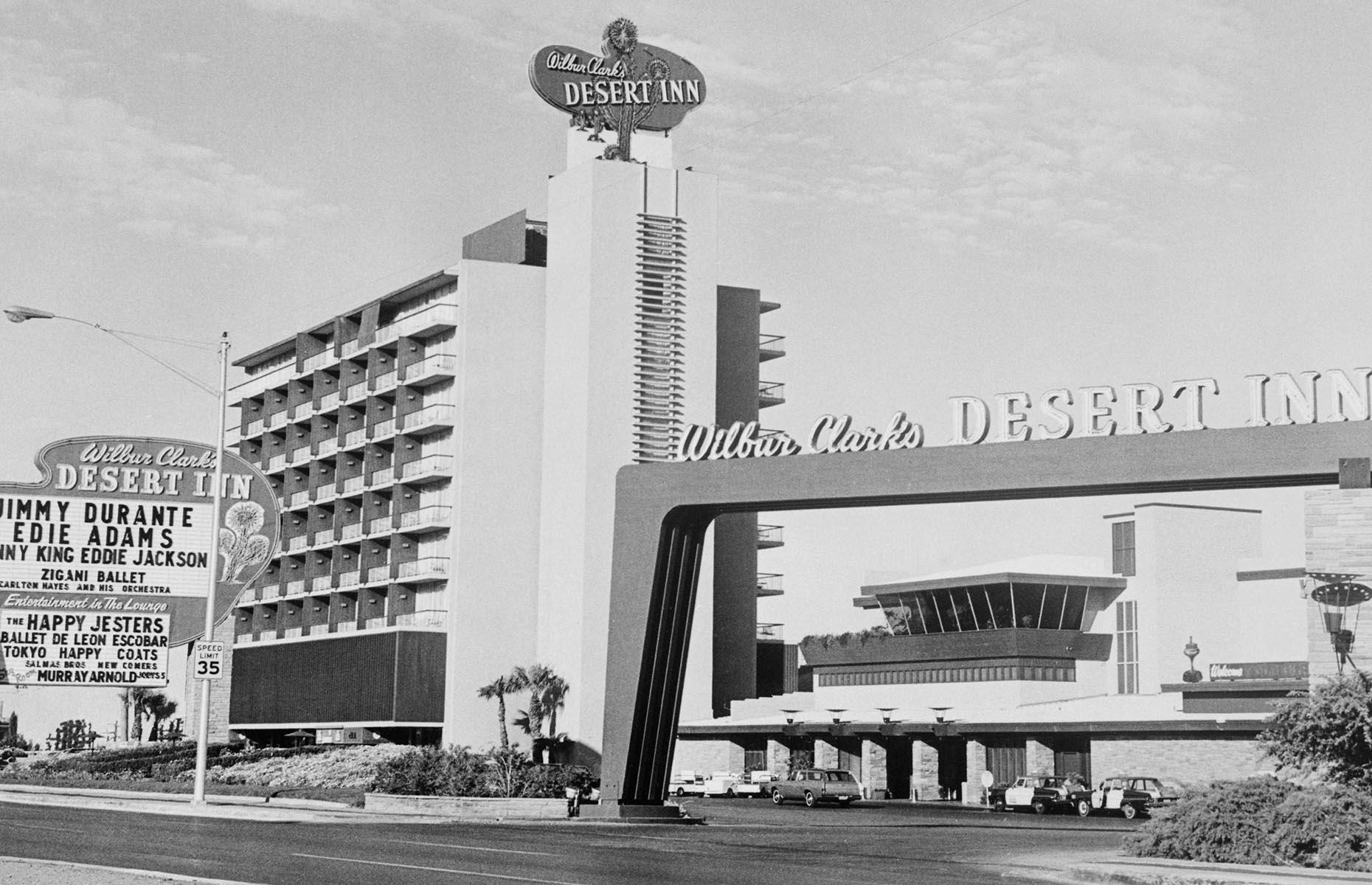 Slide 21 of 34: A business magnate from Texas, Howard Hughes began a buying spree after overstaying his booking at the Desert Inn (pictured). Unwilling to leave, he started negotiations and eventually bought the hotel. During the 1960s he went on to purchase the Desert Inn, the Sands, Frontier, Silver Slipper, Castaways and Landmark. Hughes was instrumental in changing Las Vegas' image from its Wild West roots to a refined cosmopolitan city with numerous remodelings and multi-story additions. His business model paved way for corporate ownership of hotel-casinos so common today.