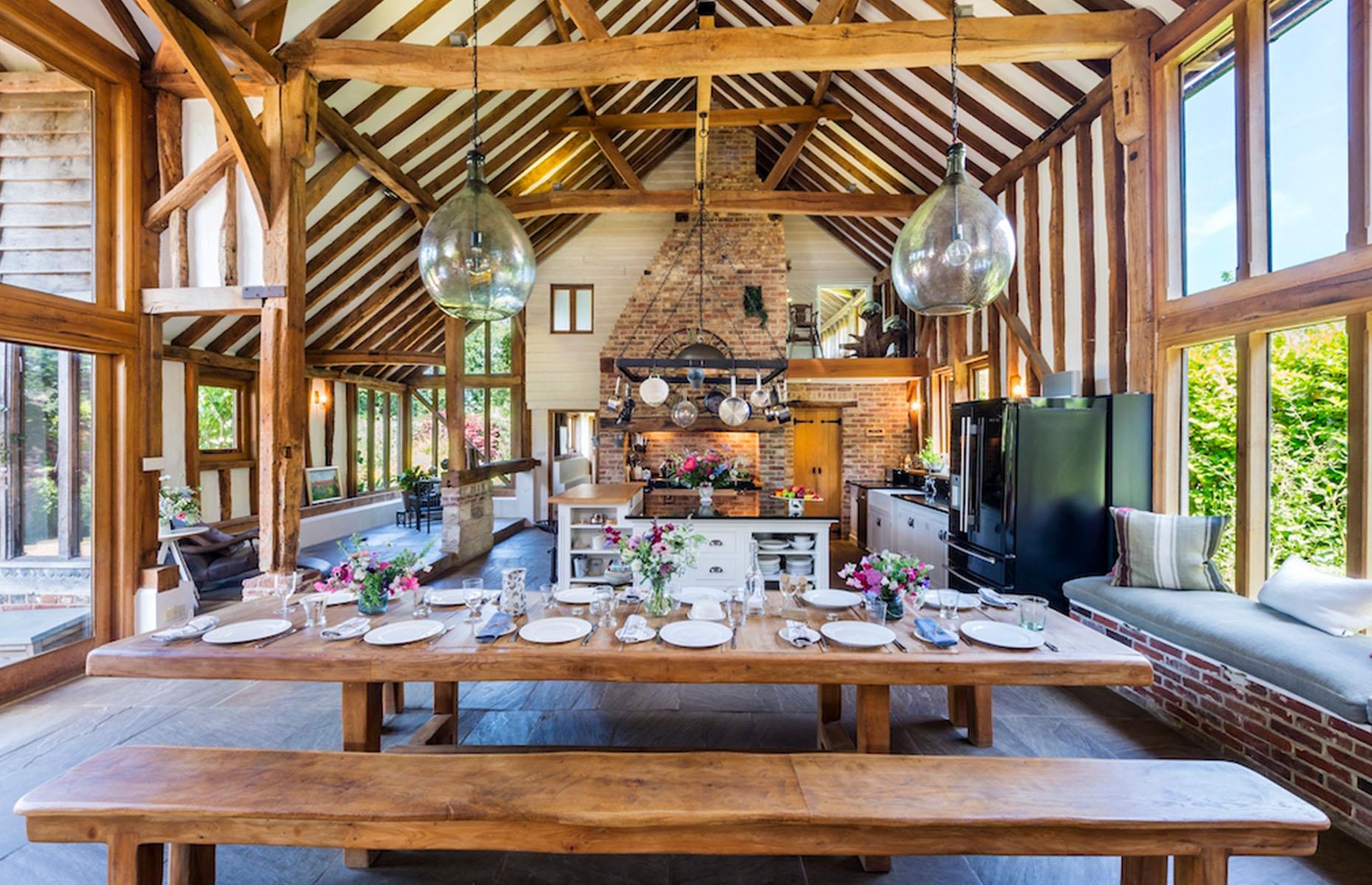 <p>If your open-plan space has characterful features like exposed beams or support columns, don't try to disguise them. Instead, let these architectural quirks enhance your scheme for a completely unique interior. In this <a href="https://www.loveproperty.com/gallerylist/64656/10-breathtaking-barn-conversions">beautiful barn conversion</a>, characterful woodwork and an original brick hearth frame a charming country-style living space.</p>