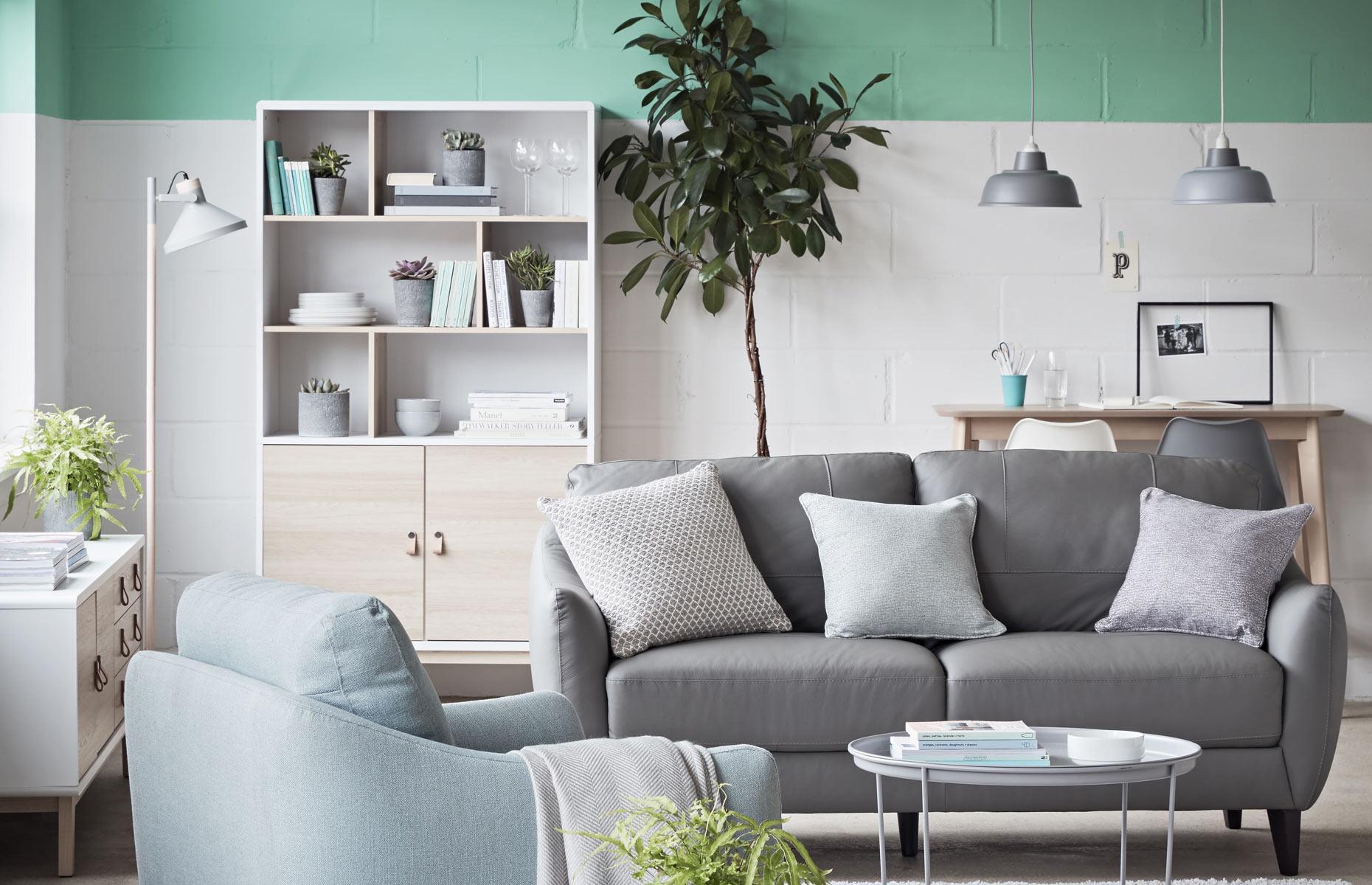 <p>Unify a small open-plan living room with an <a href="https://www.loveproperty.com/gallerylist/91682/30-paint-decorating-ideas-youll-want-to-try?page=1">on-trend paint technique</a>. When space is tight, look to the upper portion of the walls and the ceiling. Paint this upper area a refreshing shade to make a statement across the entire room. Choose crisp white for the lower parts of the walls to create contrast; it will also reflect the light and maximize the feeling of space. Blonde wood and white furniture set against the walls add to the vibrancy of this invigorating room. </p>