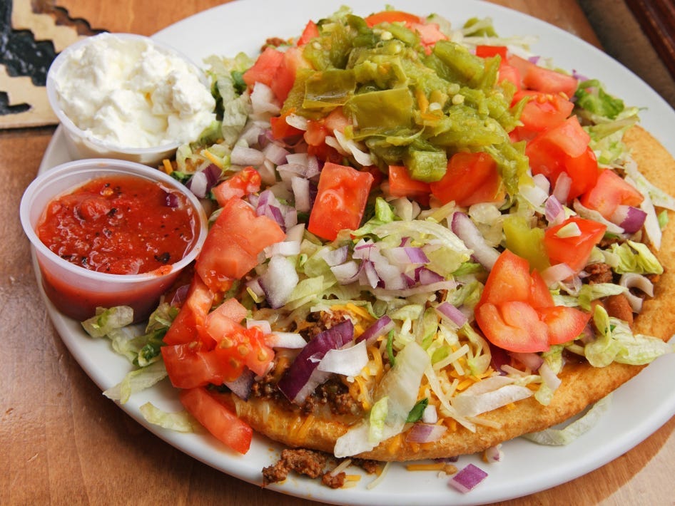<p>Also known as "Navajo tacos," these are extremely popular in Arizona. The fried dough is topped with traditional taco fillings like meat, beans, and cheese.</p>
