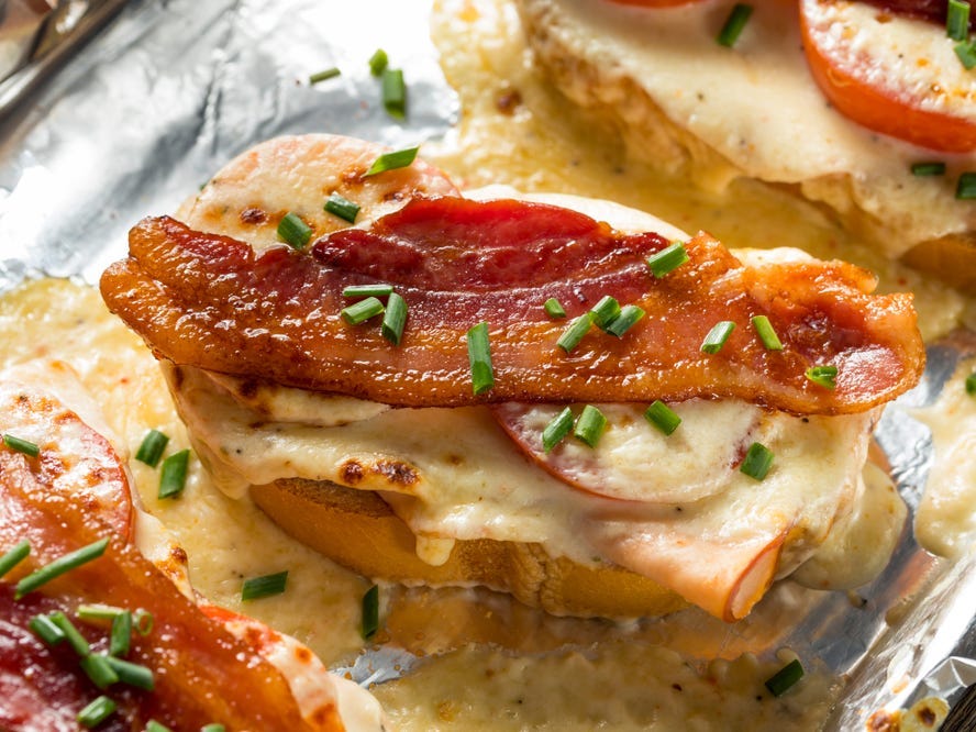 <p>The <a href="https://www.gotolouisville.com/culinary/things-to-do/hot-brown-hop/history-of-the-hot-brown">Hot Brown sandwich originated at the Brown Hotel in Louisville in 1926</a>. The open-faced sandwich with turkey and bacon is covered in cheesy Mornay sauce, and then baked or broiled until the sauce begins to brown.</p>