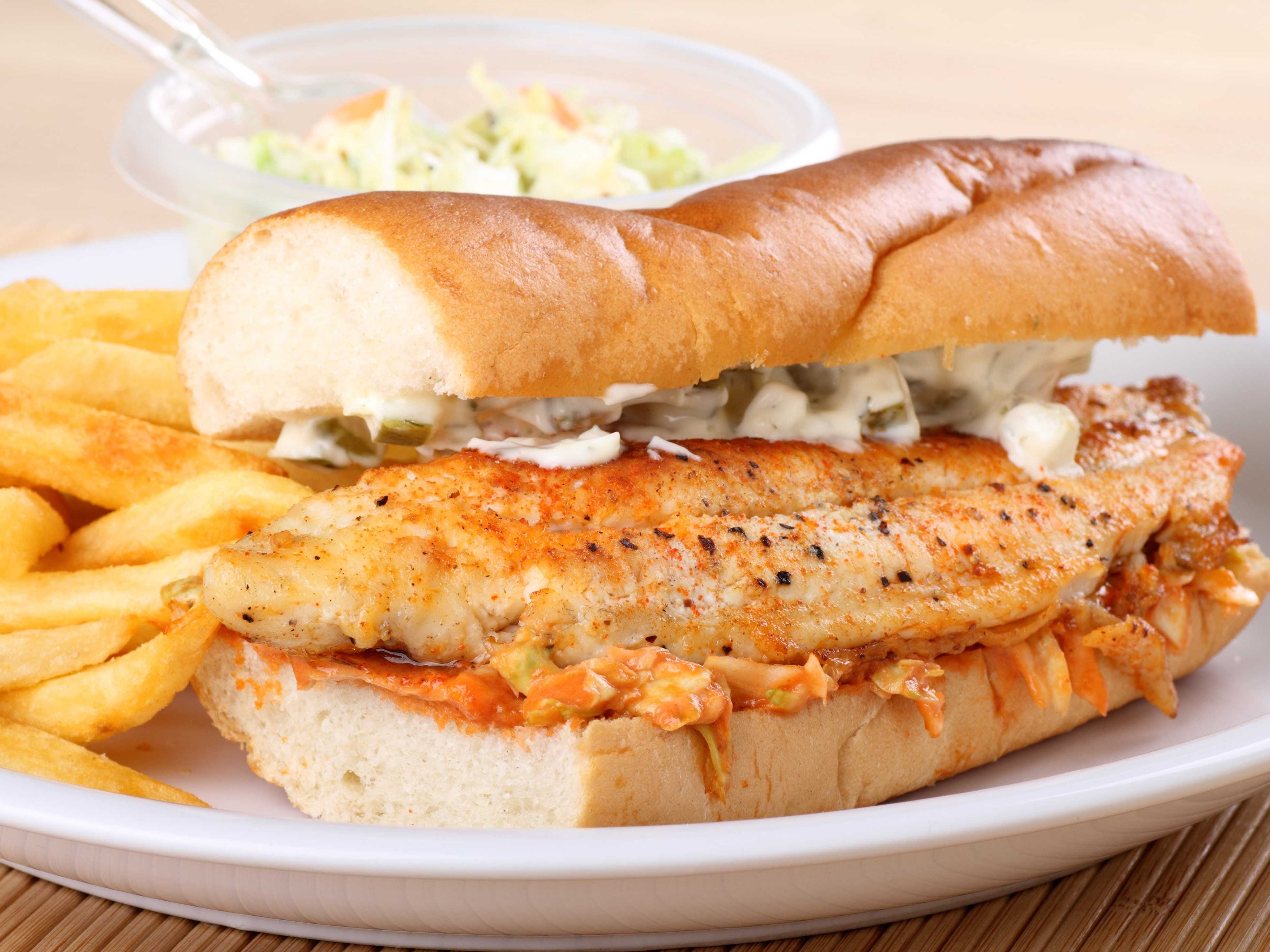 <p>Caught locally and tucked between two buttered buns, the deep-fried catfish sandwich is best paired with a side of fries and slaw.</p>