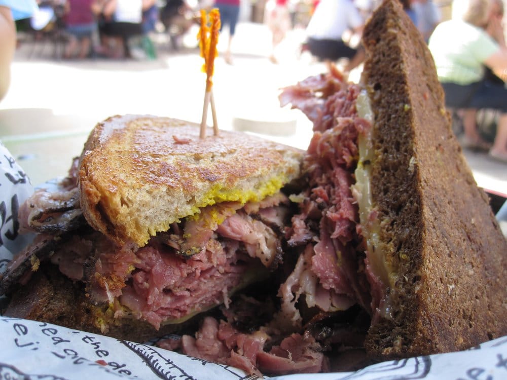 <p><a href="https://www.zingermansdeli.com/">Zingerman's Deli</a> in Ann Arbor is known for its corned beef sandwiches, especially the Oswald Mile High, which is made with corned beef and yellow mustard on double-baked, hand-sliced Jewish rye bread.</p>
