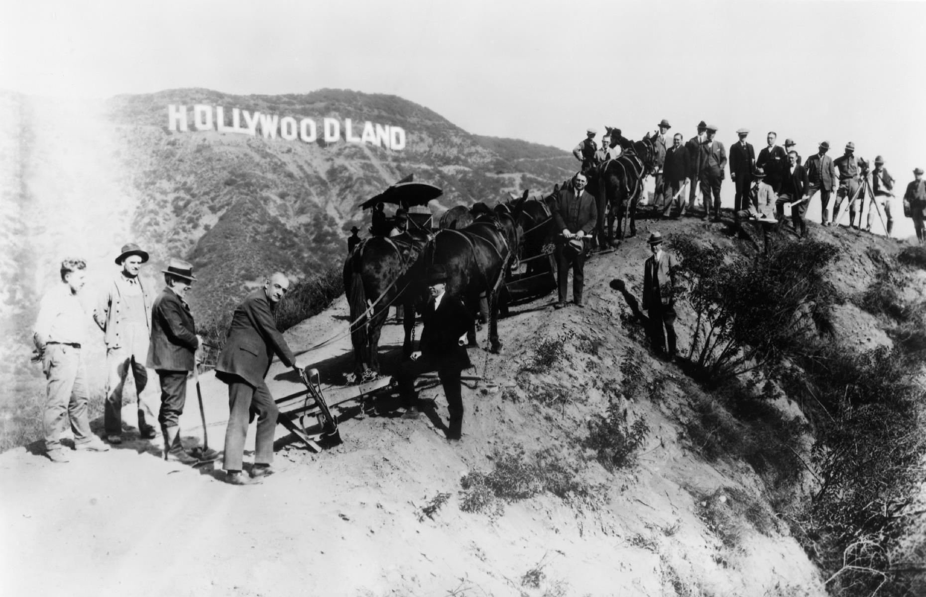 <p>You might be surprised to learn that the Hollywood sign that towers above Los Angeles once read “Hollywoodland”, as shown in this image from 1925, in which a group of surveyors pose underneath it. However in 1949, it was decided that the sign – which was originally built as a temporary advertisement for a housing development – should drop the “land”, in order to refer to the whole area. Now, the famous backdrop is captured on many tourists' cameras.</p>