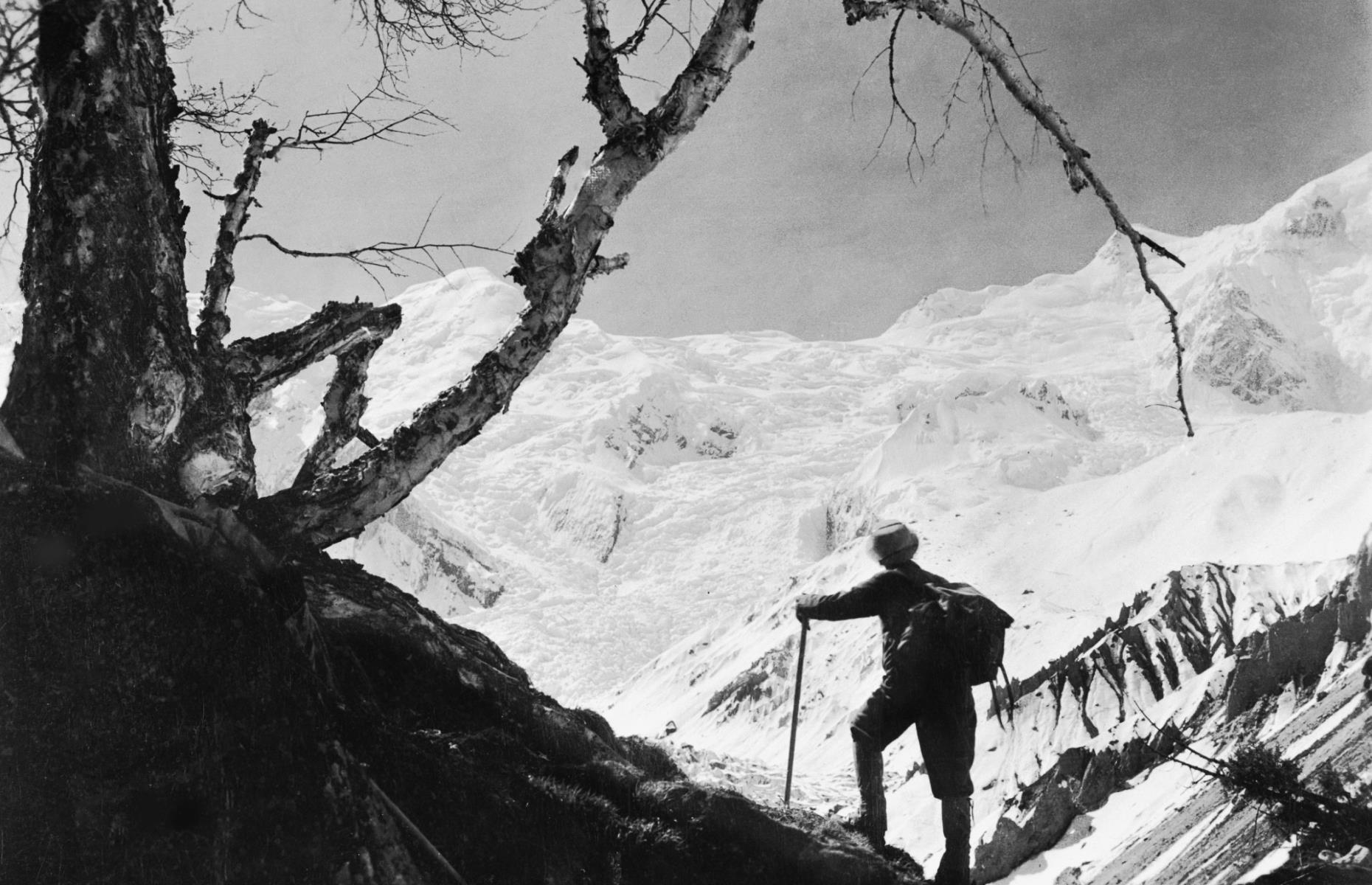 <p>The tallest mountain on the planet has fascinated people for millennia, but its summit wasn’t successfully reached until 1953, when New Zealander explorer Edmund Hillary and Nepali Sherpa Tenzing Norgay officially scaled the peak. Shown here in 1955, a climber gazes out at Mount Everest from one of the surrounding paths. However, overcrowding of the path towards the summit in recent years, fuelled in part by cut-price expeditions from Nepali trekking companies, has led to growing concerns about safety. The 2019 season was the deadliest on record, with 11 fatalities.</p>