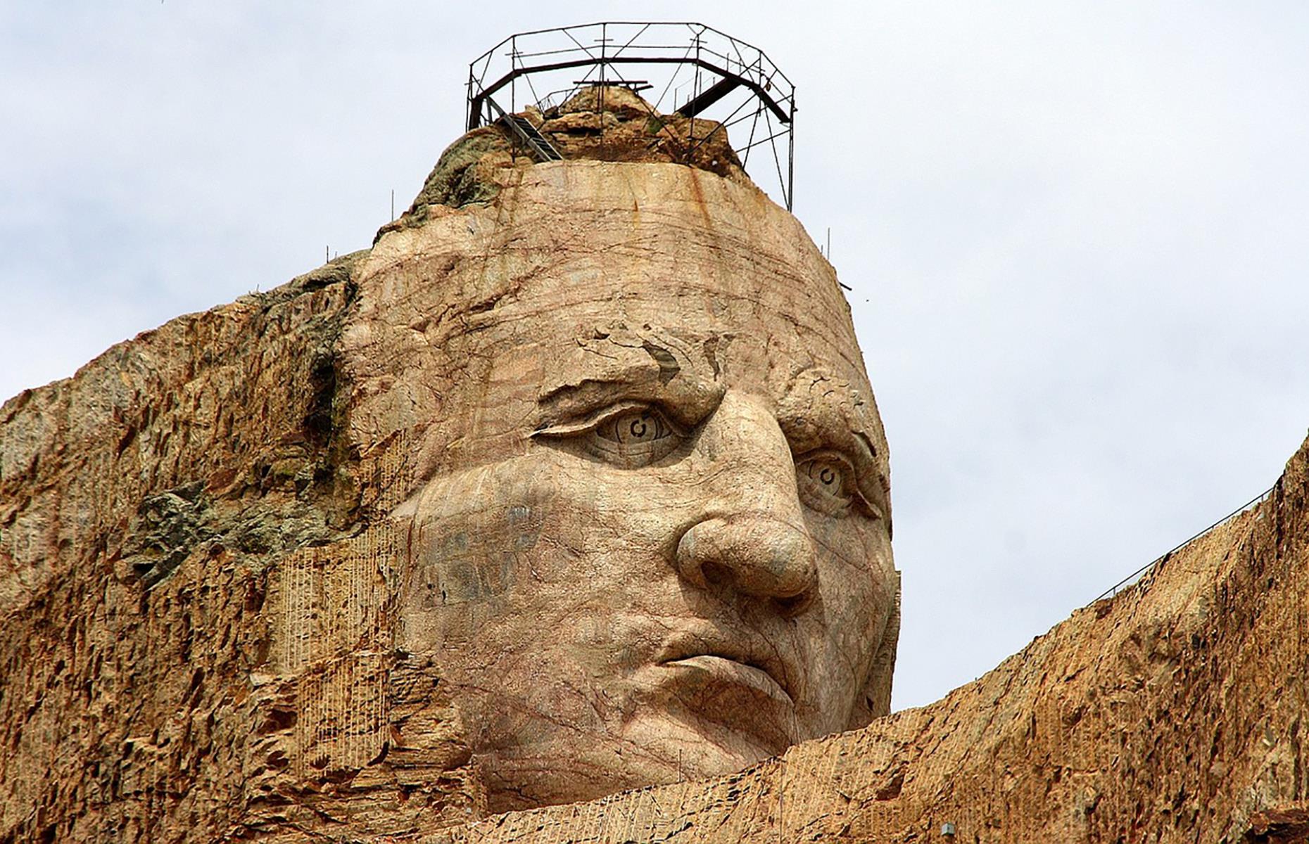 Slide 3 of 49: The tribute to Crazy Horse (pictured), a Lakota Warrior who famously led Native fighters in the Great Sioux War of 1876–77, was begun in 1948. Upon completion, it's set to be the largest mountain carving in the world, peaking at a gargantuan 563 feet (163m), and far eclipsing Mount Rushmore's mere 60 feet (18m). The landmark generally receives around one million visitors per year (a third of Mount Rushmore's) and the mammoth sculpture and its trio of museums are currently open – check here for any updates before setting out.