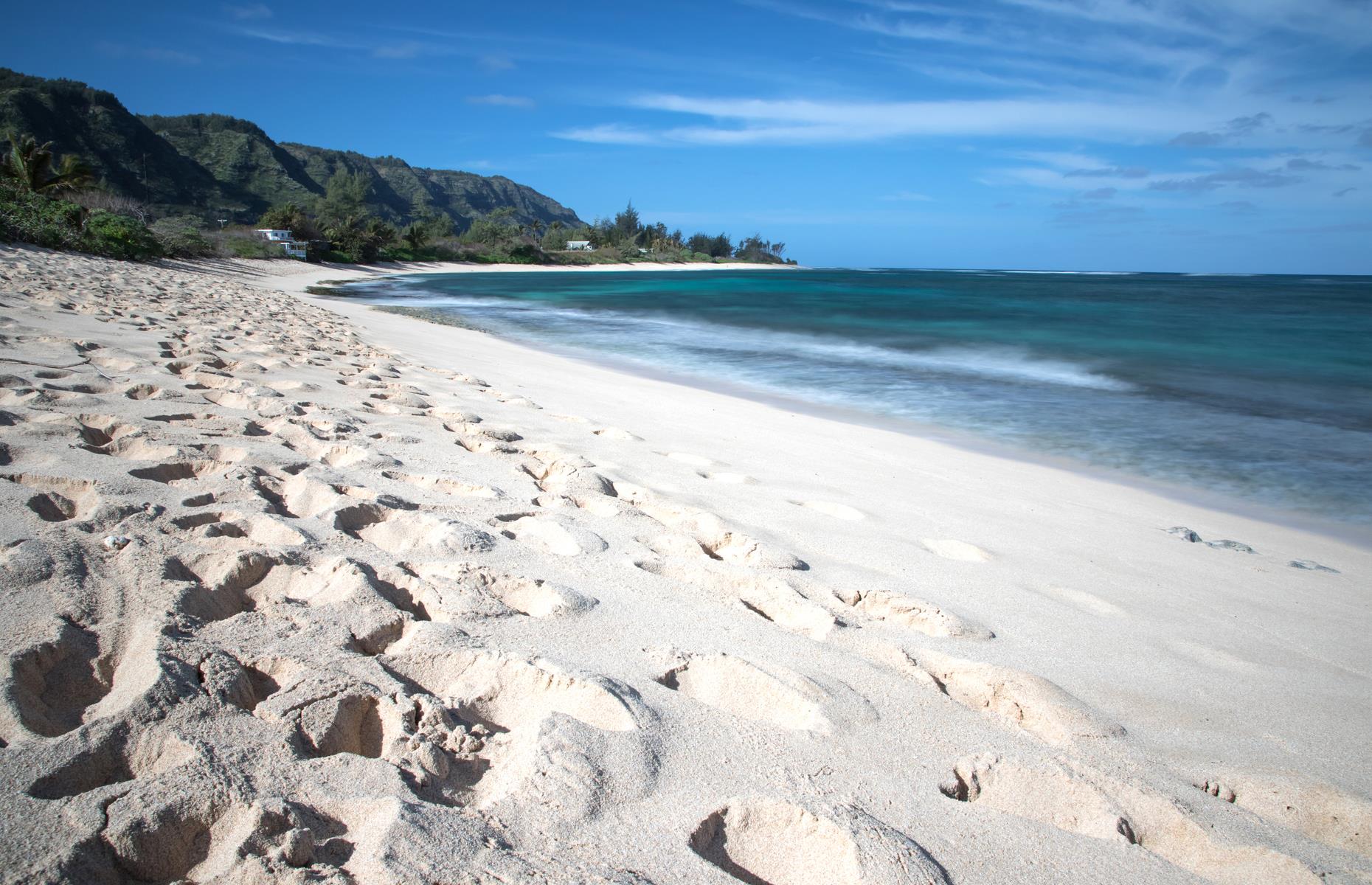 Slide 37 of 49: On Oahu's quieter North Shore, travelers will find Mokuleia Beach Park, home to a secluded arc of sand, and waters that lend themselves perfectly to wind and kite surfing. Amenities are limited here, so it's best to bring a picnic.