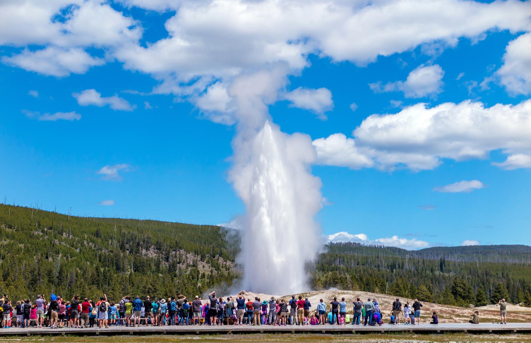 Slide 48 of 49: Yellowstone is one of the USA's largest national parks but, despite the ample space, most visitors still collect around the preserve's most famous sights. Natural wonders like the kaleidoscopic Grand Prismatic Spring and the Old Faithful geyser (pictured here on a typical busy summer's day in 2017) hog the limelight, while equally impressive sites like Castle Geyser draw far fewer crowds. 