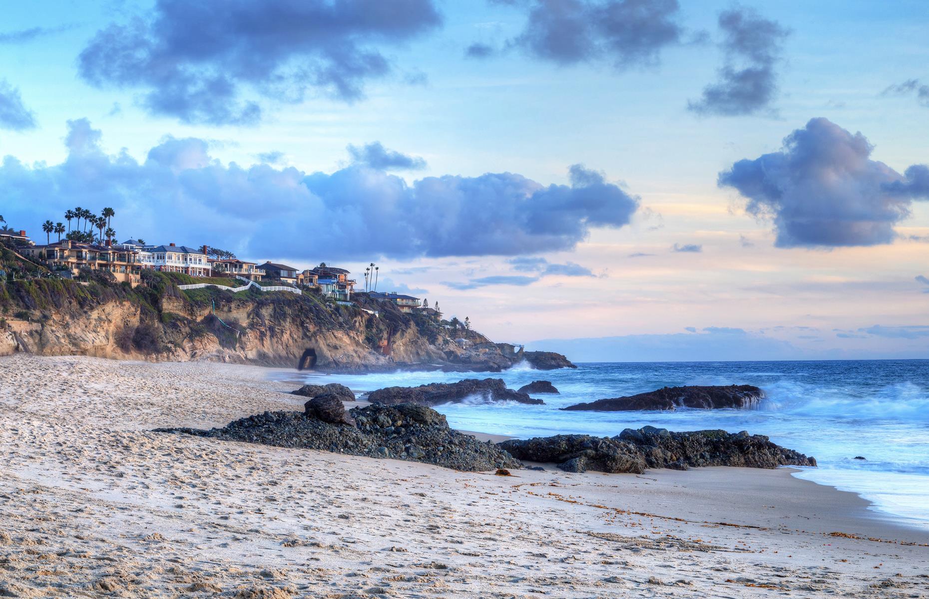 Slide 45 of 49: Around an hour away from Santa Monica, in the Orange County city of Laguna Beach, is Thousand Steps Beach. There's not actually 1,000 steps – there's just a little over 200 – but it still requires some extra effort to reach these shores. Those who make the descent will land on a gorgeous sweep of soft, pale sand fringed by sandstone cliffs and waters favored by surfers.